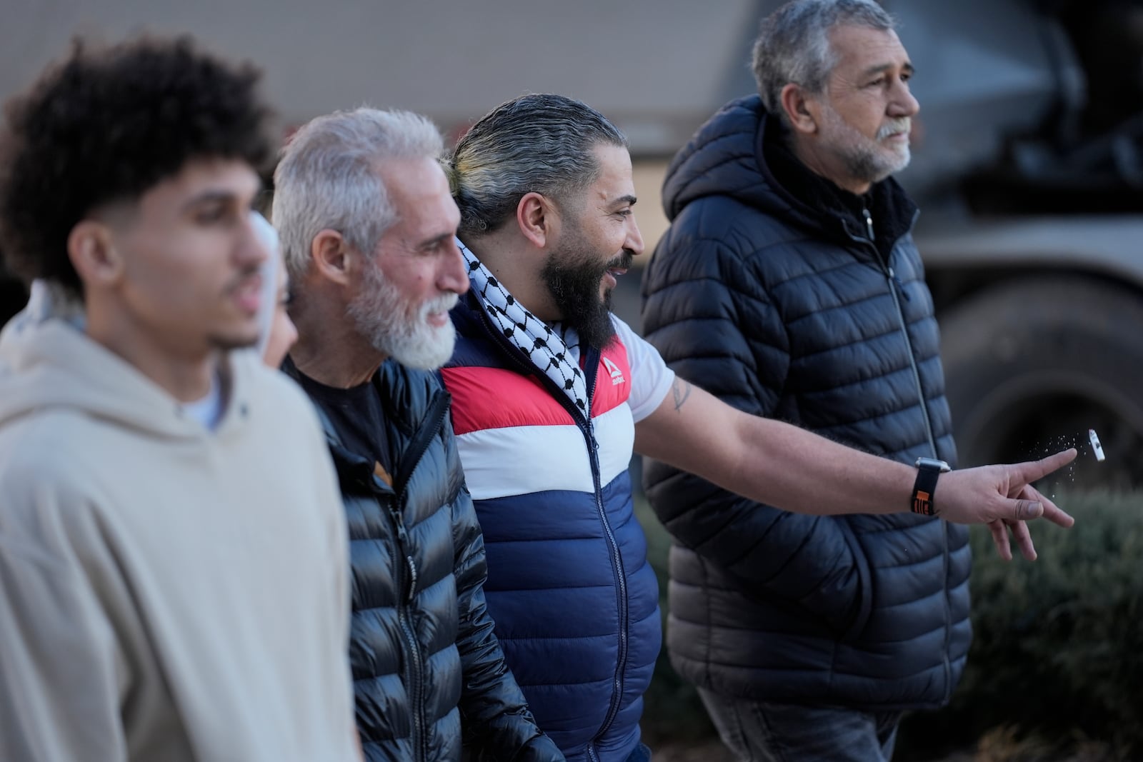 Odai Alfayoumi, second from right, father of six-year-old Palestinian boy Wadee Alfayoumi, leaves Will County Courthouse with others where Joseph Czuba, 73, is charged with and on trial in the fatal stabbing of the boy and the wounding of his mother Hanan Shaheen, Tuesday, Feb. 25, 2025, in Joliet, Ill. (AP Photo/Erin Hooley)