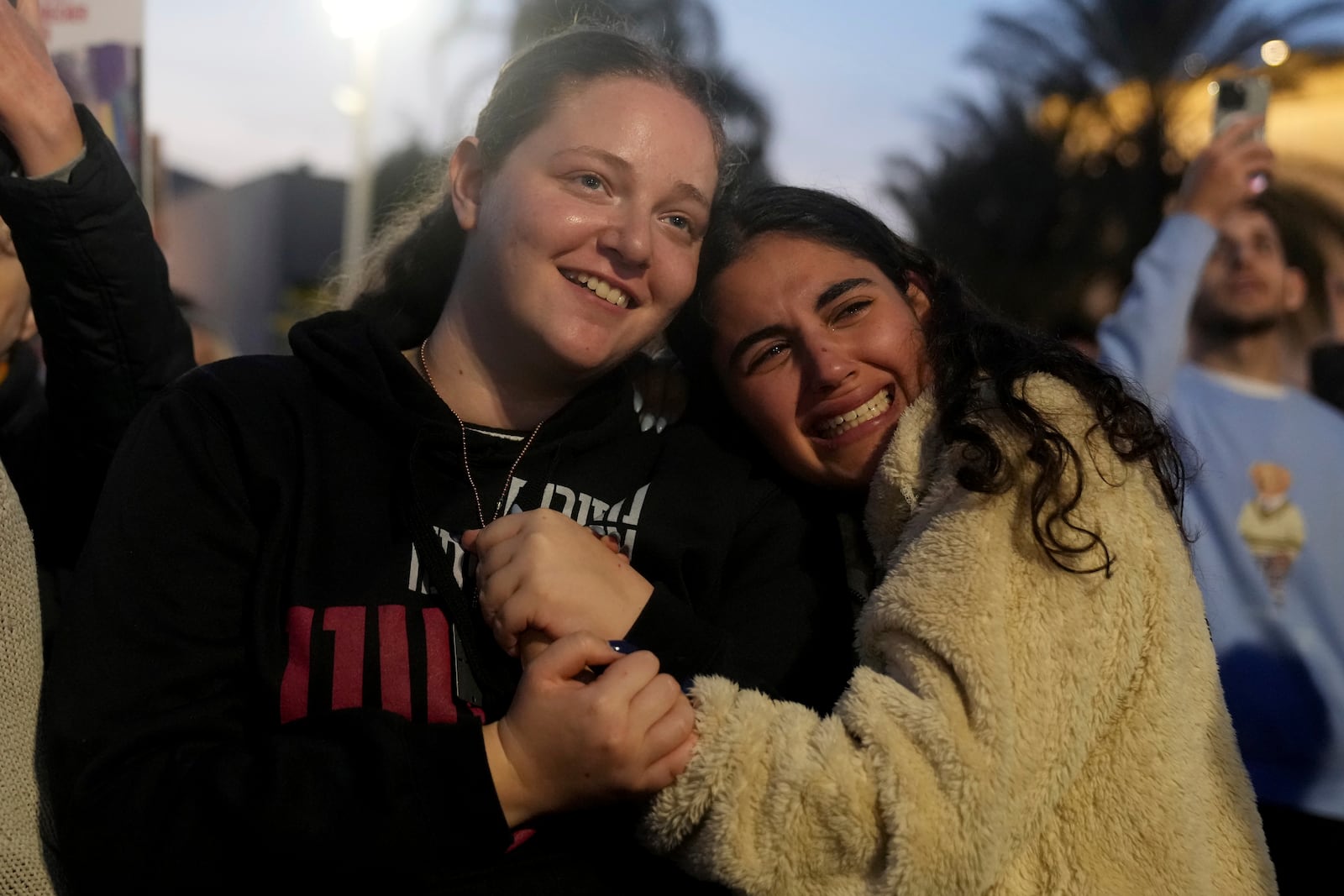 Relatives and friends of people killed and abducted by Hamas and taken into Gaza, react as they gather in Tel Aviv, Israel on Sunday, Jan. 19, 2025. (AP Photo/Maya Alleruzzo)