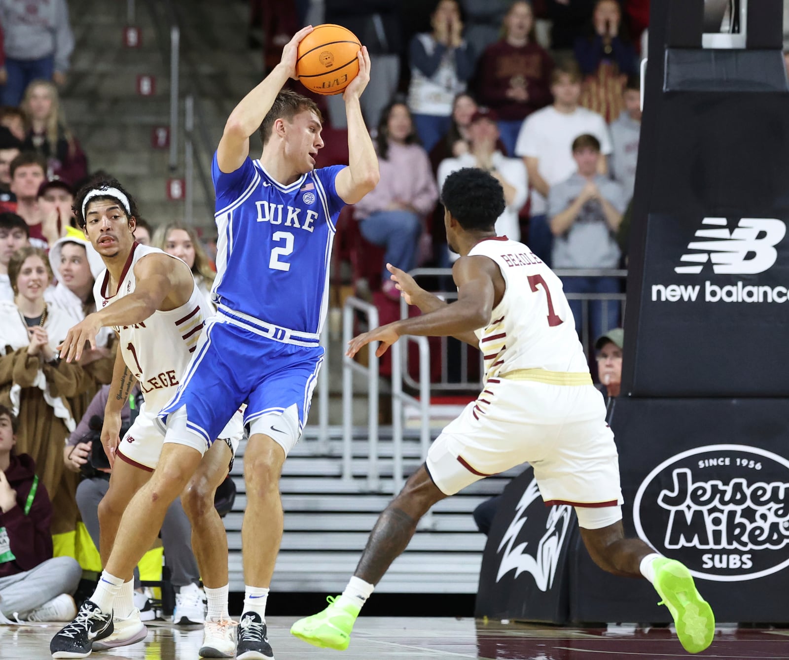 Duke guard Cooper Flagg (2) grabs a rebound between Boston College guards Dion Brown (1) and Joshua Beadle (7) during the second half of an NCAA college basketball game Saturday, Jan. 18, 2025, in Boston. (AP Photo/Mark Stockwell)