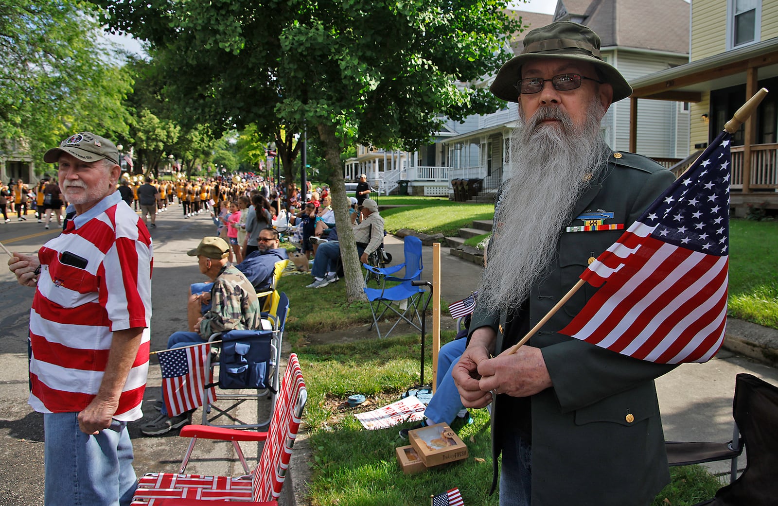 Hundreds of people put on their best red, white and blue attire and came out to watch the Springfield Memorial Day Monday, May 27, 2024. Men, women and children waved American flags and cheered as the parade marched by with veterans, flags, firetrucks and bands paying tribute to the nations fallen service men and women. BILL LACKEY/STAFF