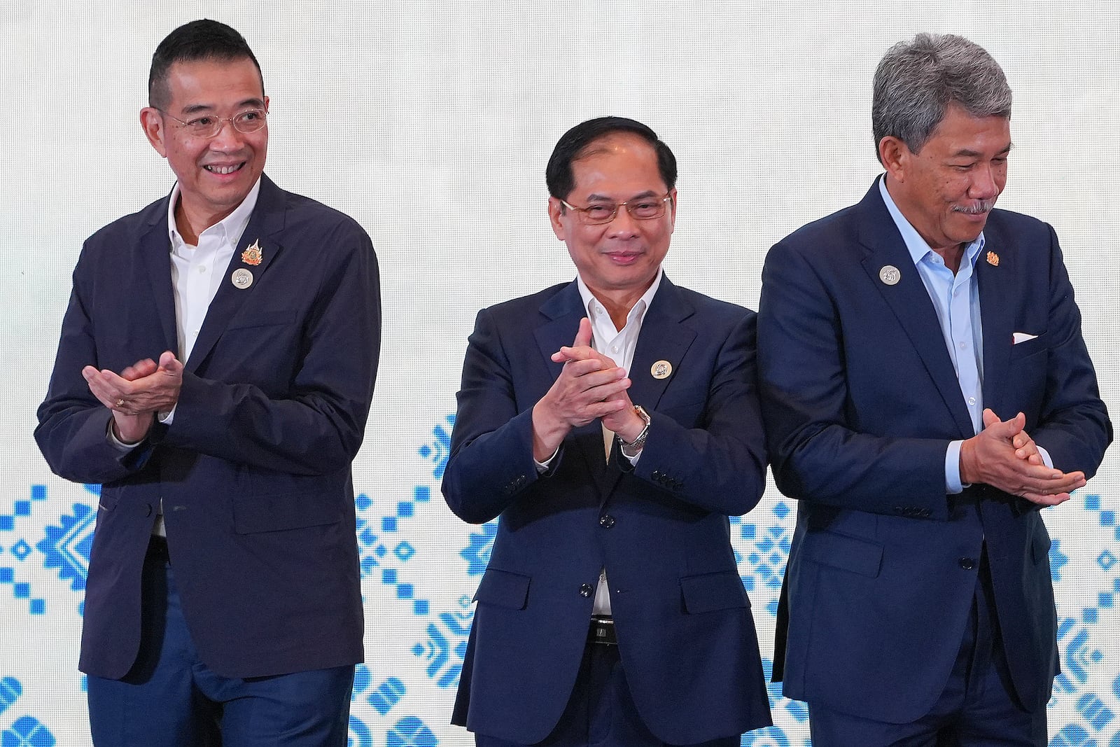 From left to right, Thailand's Foreign Minister Maris Sangiampongsa, Vietnam's Foreign Minister Bui Thanh Son and Malaysia's Foreign Minister Mohamad Hasan clap after a group photo session during the Association of Southeast Asian Nations (ASEAN) Foreign Ministers' Retreat in Langkawi Island, Malaysia Sunday, Jan. 19, 2025. (AP Photo/Azneal Ishak, Pool)