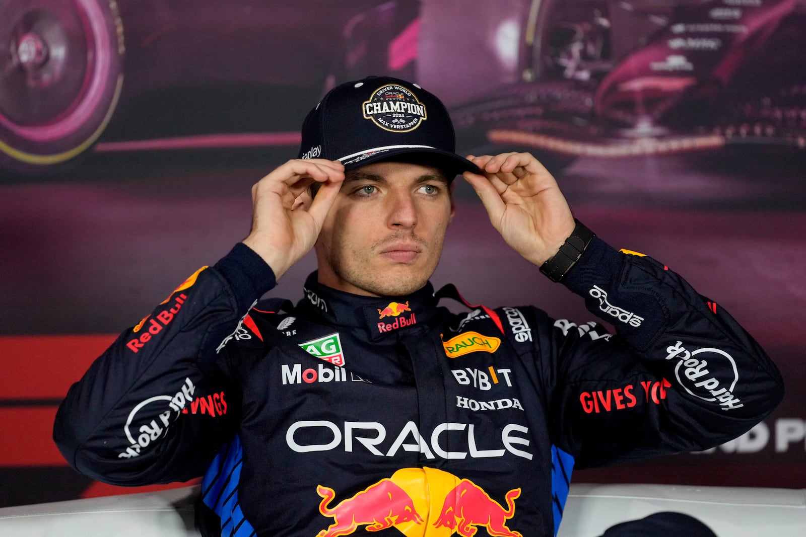 Red Bull driver Max Verstappen, of the Netherlands, adjusts his hat while conducting an interview after the F1 Las Vegas Grand Prix auto race, Sunday, Nov. 24, 2024, in Las Vegas. (AP Photo/Matt York)