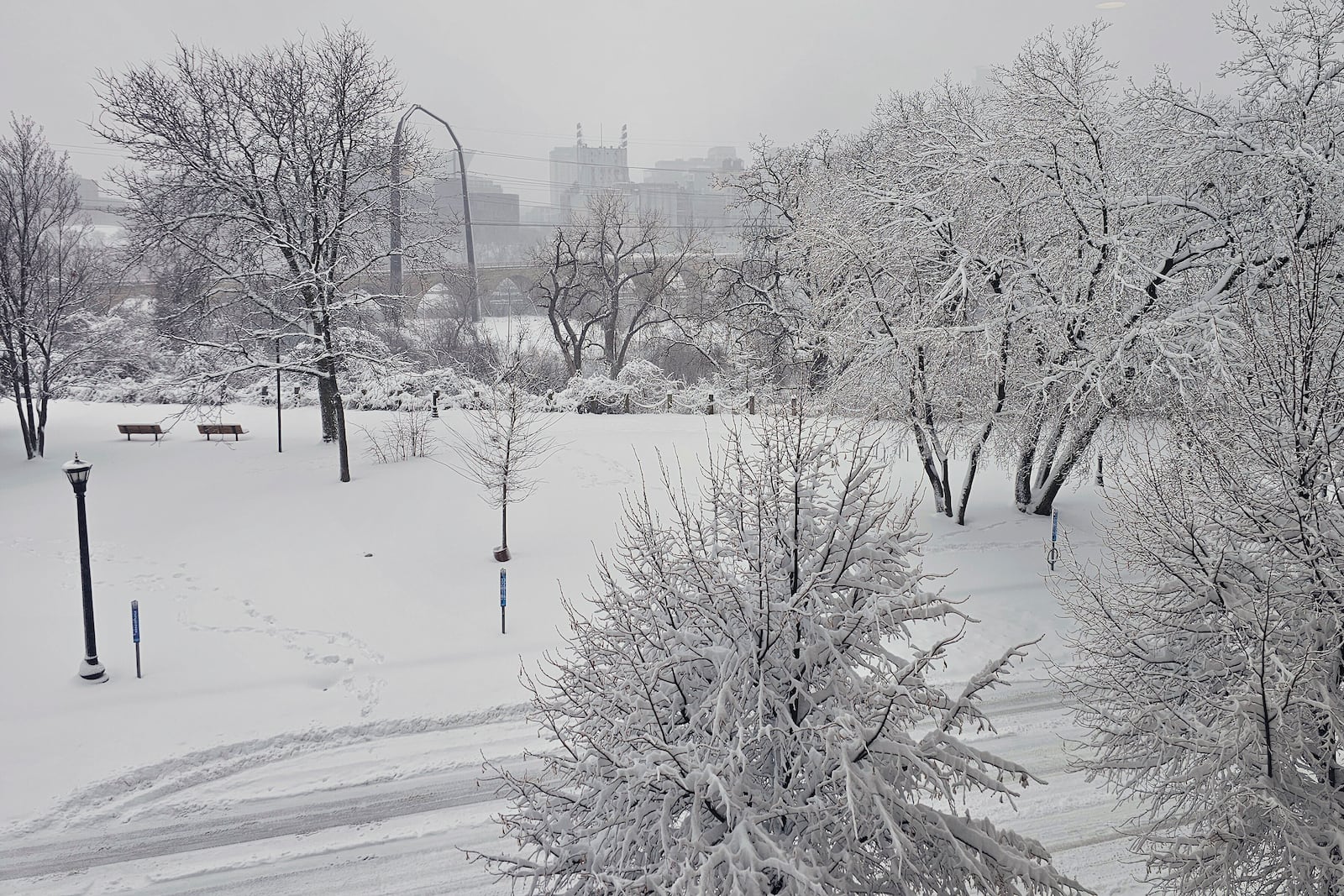 The heaviest snowfall of the season blankets Father Hennepin Park in Minneapolis and obscures the downtown skyline on Wednesday, March 5, 2025. (AP Photo/Steve Karnowski)