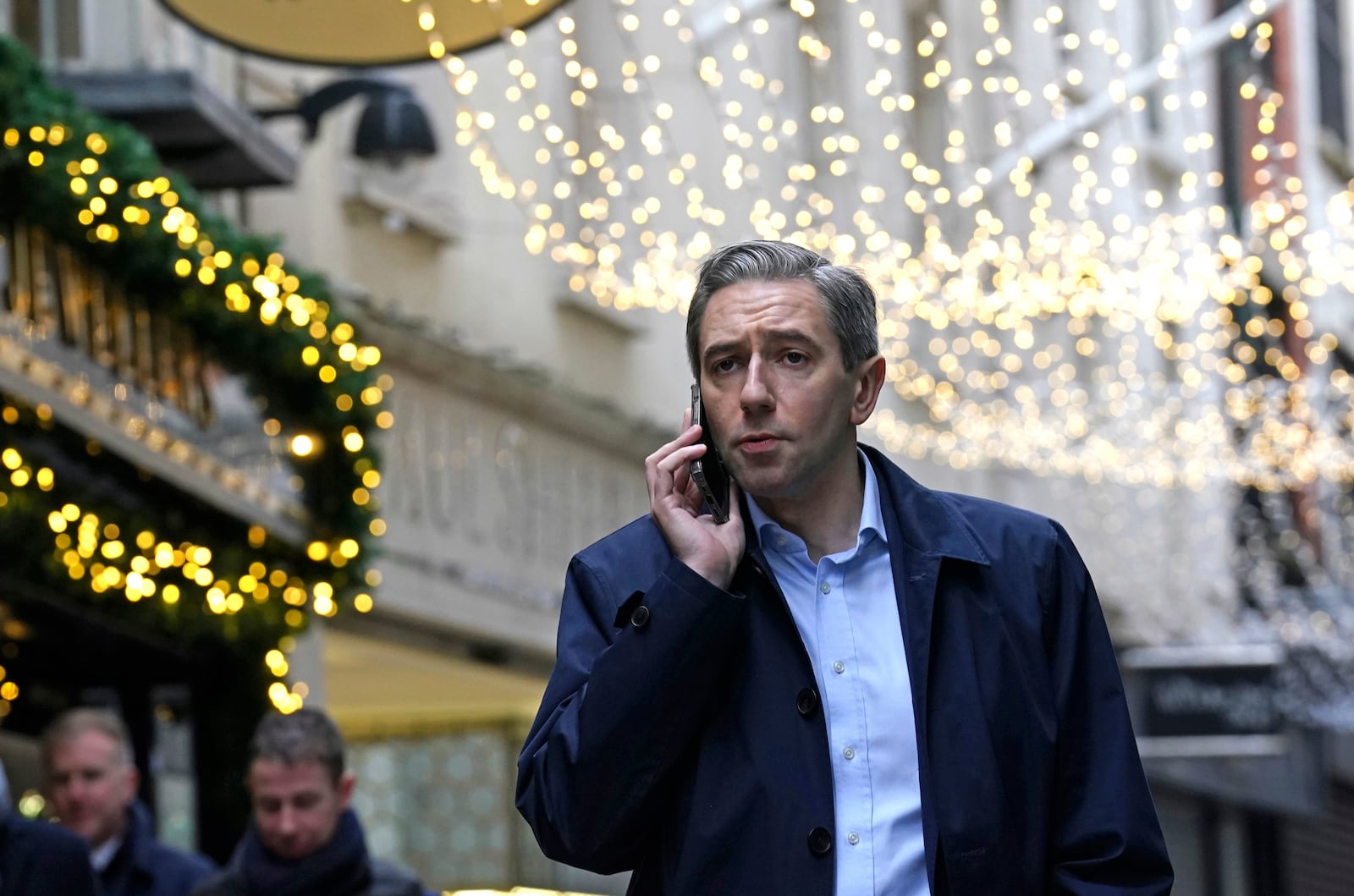 Irish Prime Minister and Fine Gael leader Simon Harris, center, speaks on the phone during a walkabout on the last day of campaigning, on the eve of the General Election, in Dublin, Thursday, Nov. 28, 2024. (Brian Lawless/PA via AP)