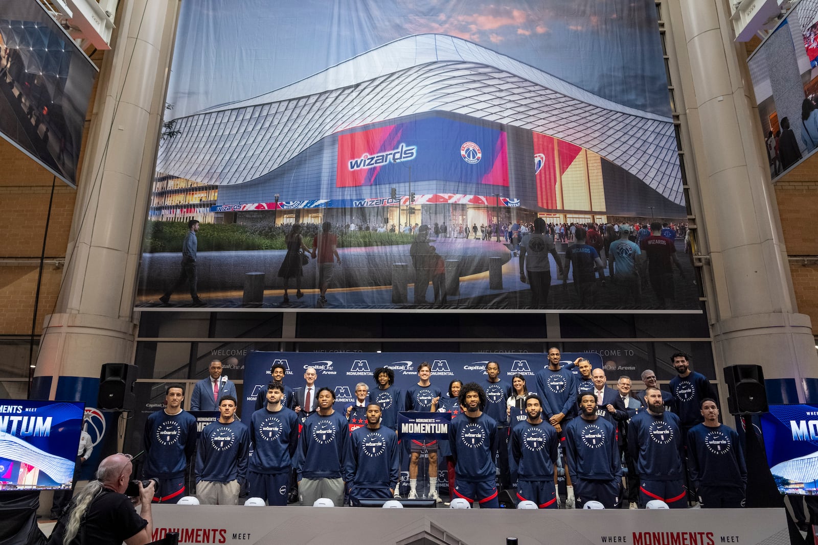 Members of the Washington Wizards NBA Basketball team pose for a photograph with Ted Leonsis, owner of the Washington Wizards NBA basketball team and Washington Capitals NHL hockey team, NBA Commissioner Adam Silver, District of Columbia Mayor Muriel Bowser, and other officials, during an event announcing the start of work on a new Capital One Arena Gallery Place Atrium, Thursday, Dec. 19, 2024, in Washington. (AP Photo/Jacquelyn Martin)