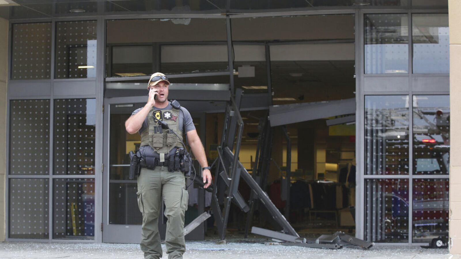 A state police officer stands outside of a Woodfield Mall entrance after a man drove an SUV into a Sears store in the Chicago suburb of Schaumburg, Ill., on Friday, Sept. 20, 2019.