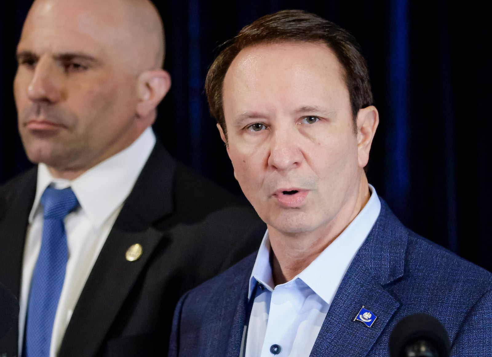 Louisiana Gov. Jeff Landry speaks as Christopher Raia, deputy assistant director of the counterterrorism division of the FBI, left, listens during a news conference at the FBI Headquarters in New Orleans, Sunday, Jan. 5, 2025, to release new information about Shamsud-Din Jabbar, the man who carried out an attack on New Orleans' Bourbon Street on New Year's Day. (Scott Threlkeld/The Times-Picayune/The New Orleans Advocate via AP)