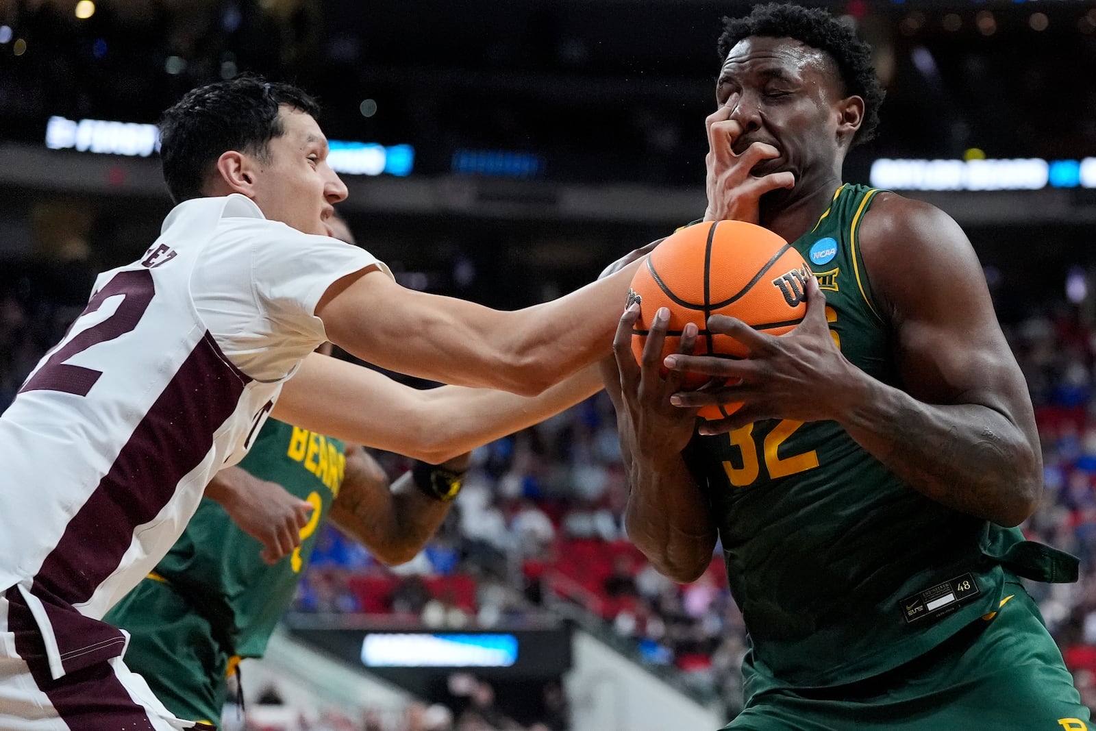 Baylor guard Jalen Celestine (32) is fouled against by Mississippi State forward RJ Melendez, left, during the first half in the first round of the NCAA college basketball tournament, Friday, March 21, 2025, in Raleigh, N.C. (AP Photo/Stephanie Scarbrough)