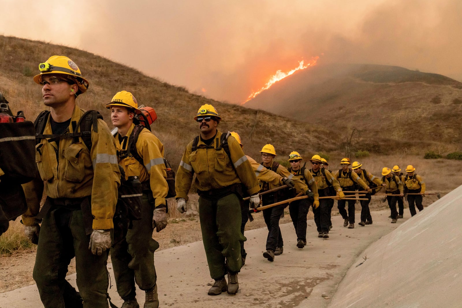 Fire crews battle the Kenneth Fire in the West Hills section of Los Angeles, Thursday, Jan. 9, 2025. (AP Photo/Ethan Swope)