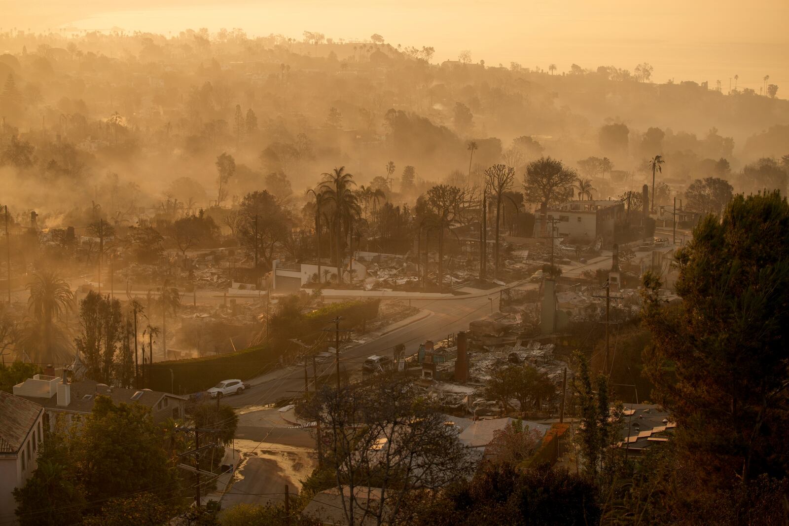 FILE - The devastation of the Palisades Fire is seen in the early morning in the Pacific Palisades neighborhood of Los Angeles, Friday, Jan. 10, 2025. (AP Photo/John Locher, File)