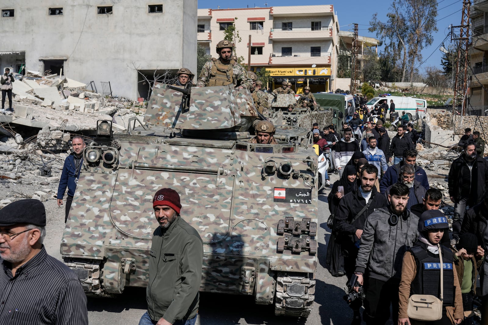 Lebanese soldiers and Lebanese citizens enter a neighbourhood in the southern Lebanese village of Aitaroun, Lebanon, Monday, Jan. 27, 2025. (AP Photo/Bilal Hussein)