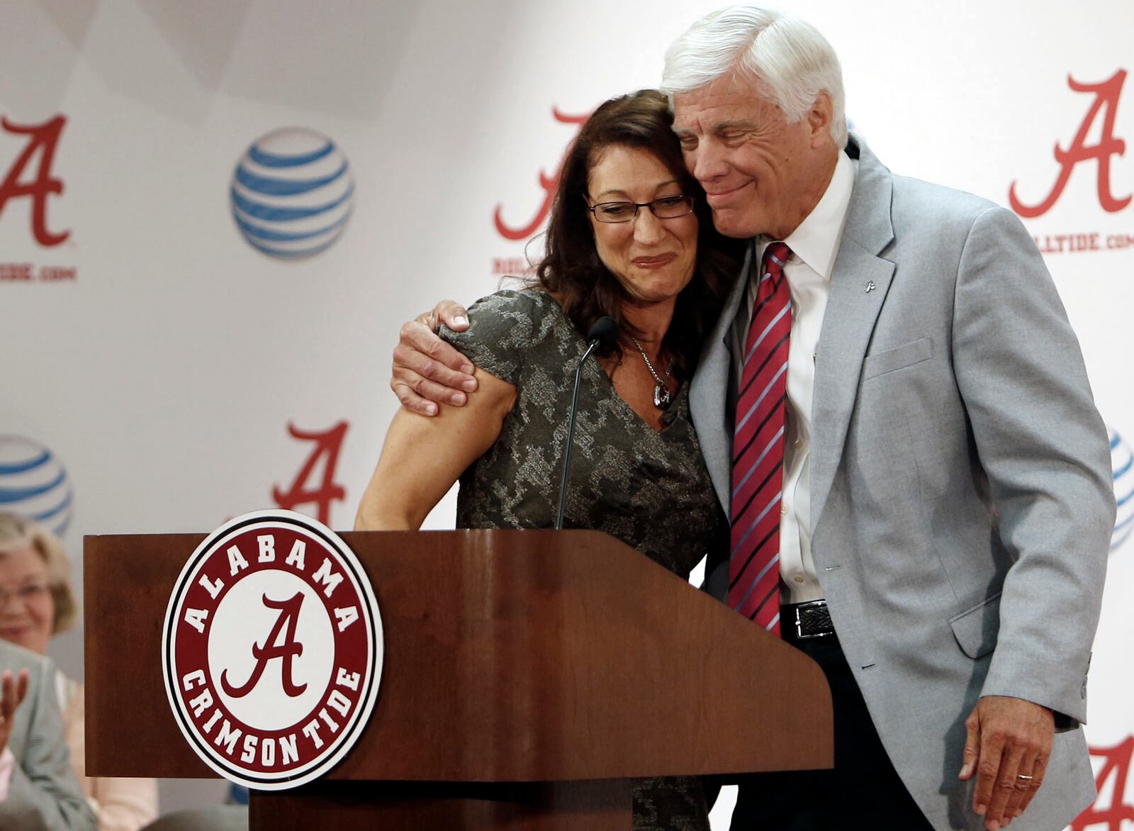 FILE - Athletic Director Bill Battle gives Dana Duckworth a hug as she addresses the media about her appointment as head coach of the University of Alabama gymnastics team during a news conference in the Mal M. Moore Athletic Building, July 15, 2014, in Tuscaloosa, Ala. (Erin Nelson/The Tuscaloosa News via AP, File)