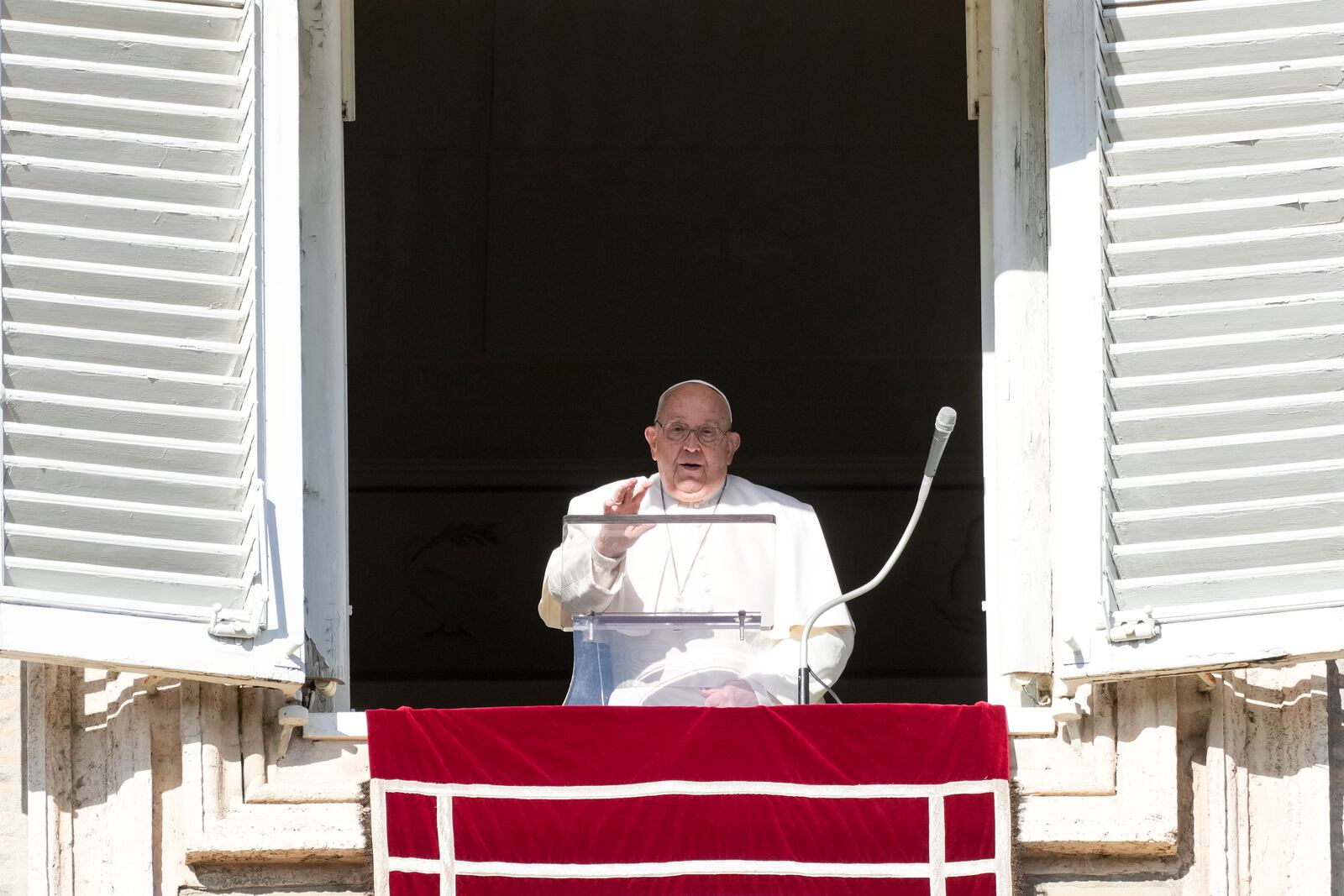 Pope Francis delivers his blessing as he recites the Angelus noon prayer from the window of his studio overlooking St.Peter's Square, at the Vatican, Thursday, Dec. 26, 2024. (AP Photo/Andrew Medichini)