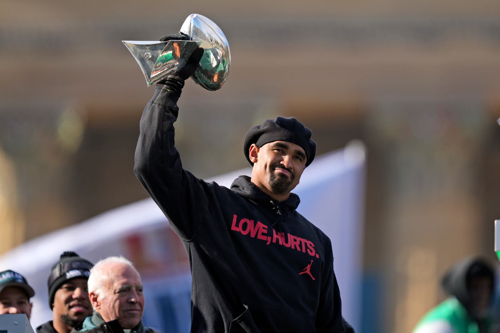 Philadelphia Eagles quarterback Jalen Hurts holds up the Lombardi trophy as he speaks during the team's NFL football Super Bowl 59 parade and celebration, Friday, Feb. 14, 2025, in Philadelphia. (AP Photo/Matt Rourke)