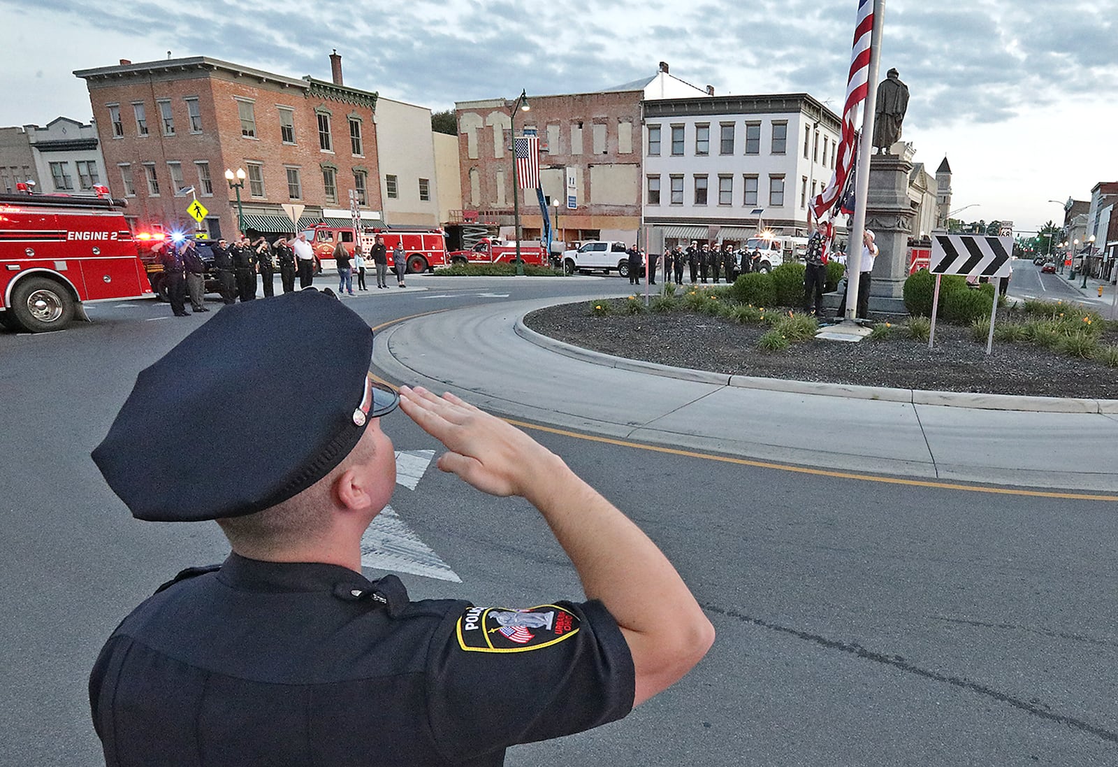 Fire Departments and members of law enforcement from around Champaign County circled Monument Square in downtown Urbana Saturday morning as the flag is lowered in remembrance of the victims of 9/11. BILL LACKEY