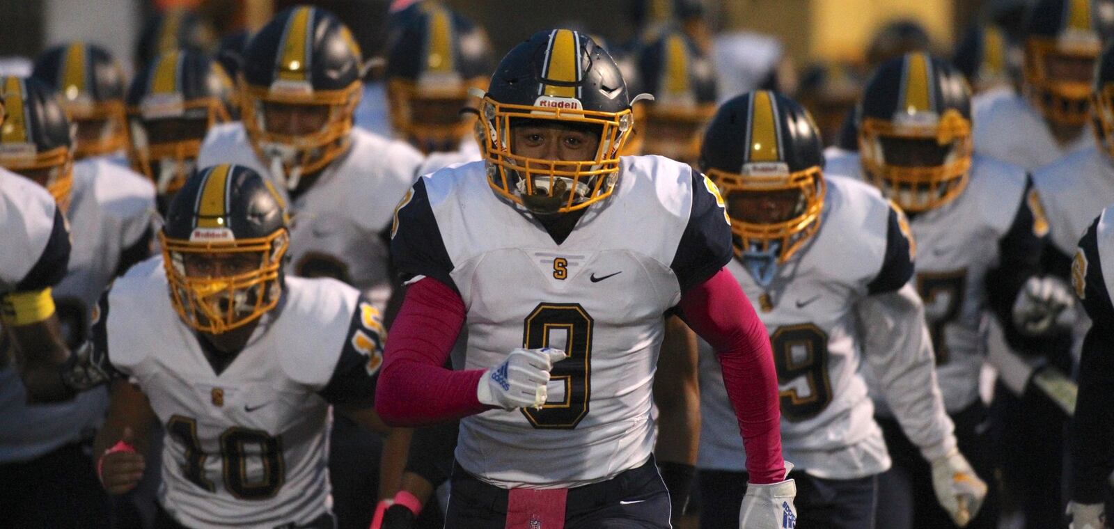 Springfield players take the field before a game against Beavercreek on Friday, Oct. 12, 2018, at Beavercreek. David Jablonski/Staff