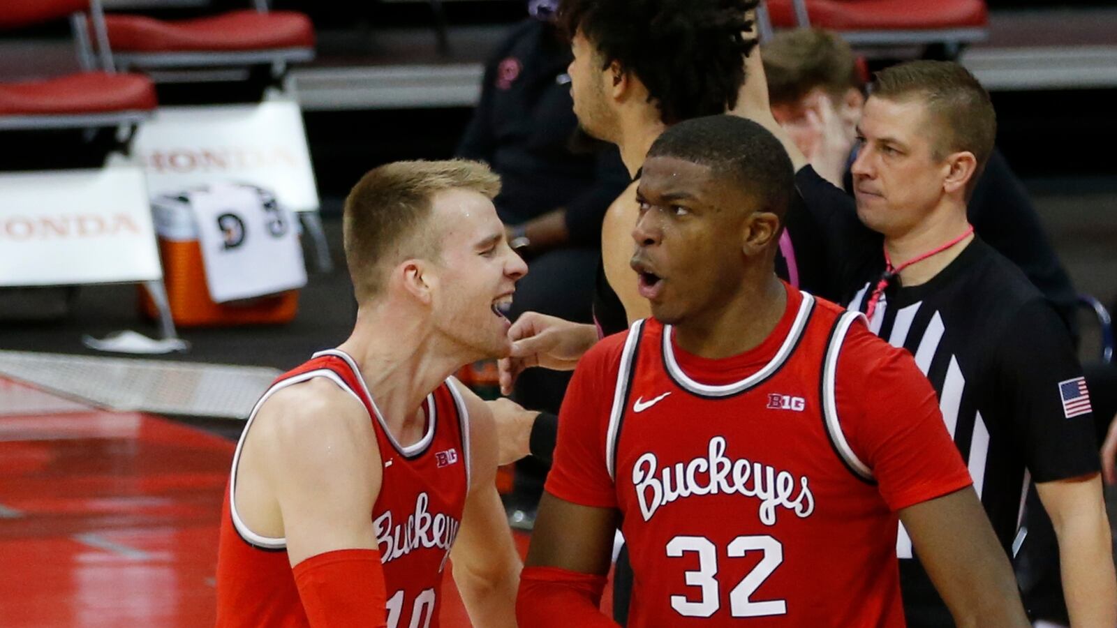 Ohio State's E.J. Liddell, right, celebrates grabbing with teammate Justin Ahrens during the second half of an NCAA college basketball game Wednesday, Jan. 27, 2021, in Columbus, Ohio. Ohio State beat Penn State 83-79. (AP Photo/Jay LaPrete)