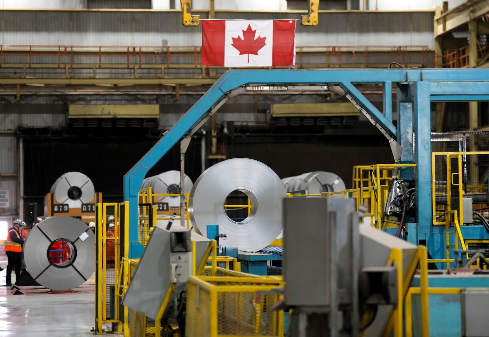 Steel workers work at the ArcelorMittal Dofasco steel plant in Hamilton, Ont., on Wednesday, March 12, 2025.(Nathan Denette /The Canadian Press via AP)