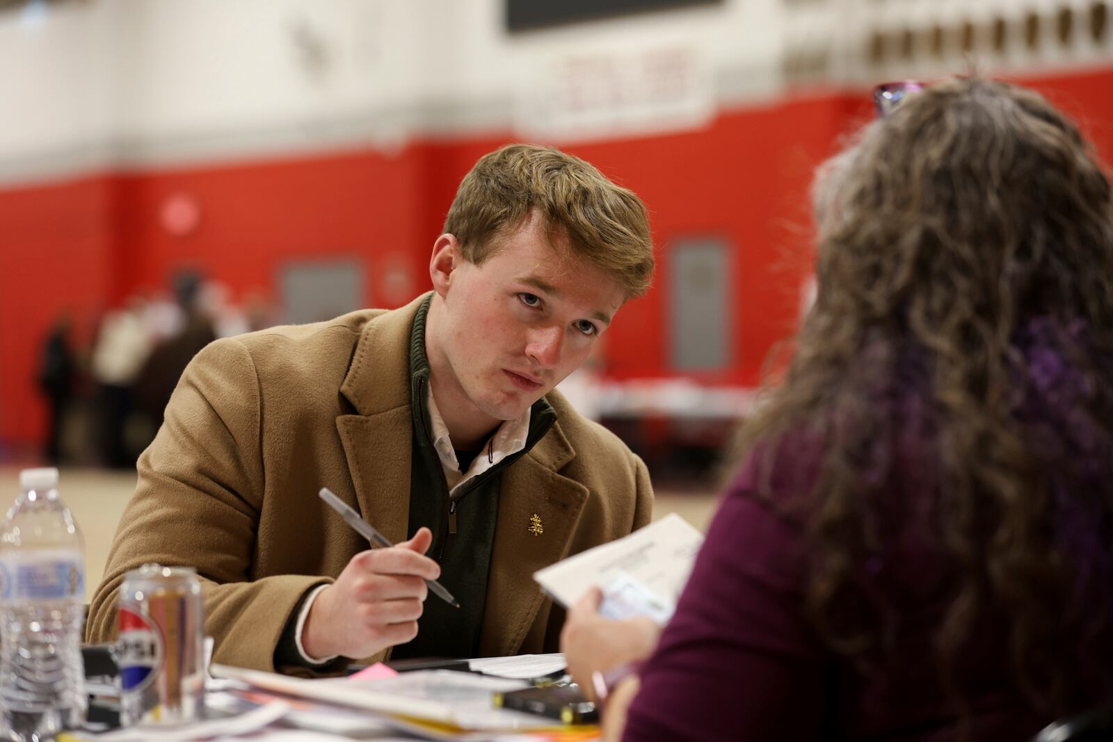 Michael Appleton registers to vote in Derry, N.H., Tuesday, March 11, 2025. (AP Photo/Reba Saldanha)