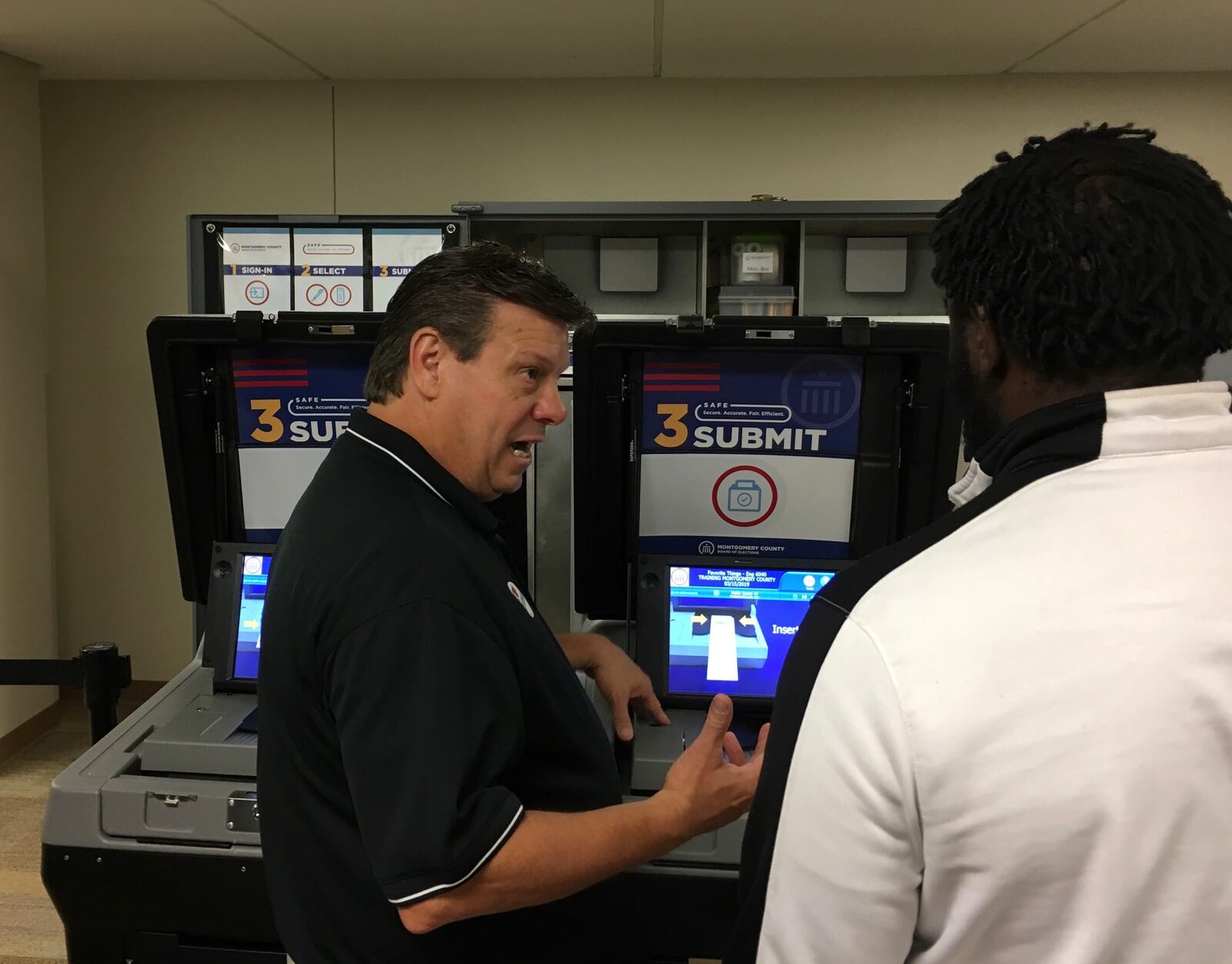 Steve Harsman, deputy director of the Montgomery County Board of Elections, explains how newer voting machines function. BONNIE MEIBERS/ STAFF