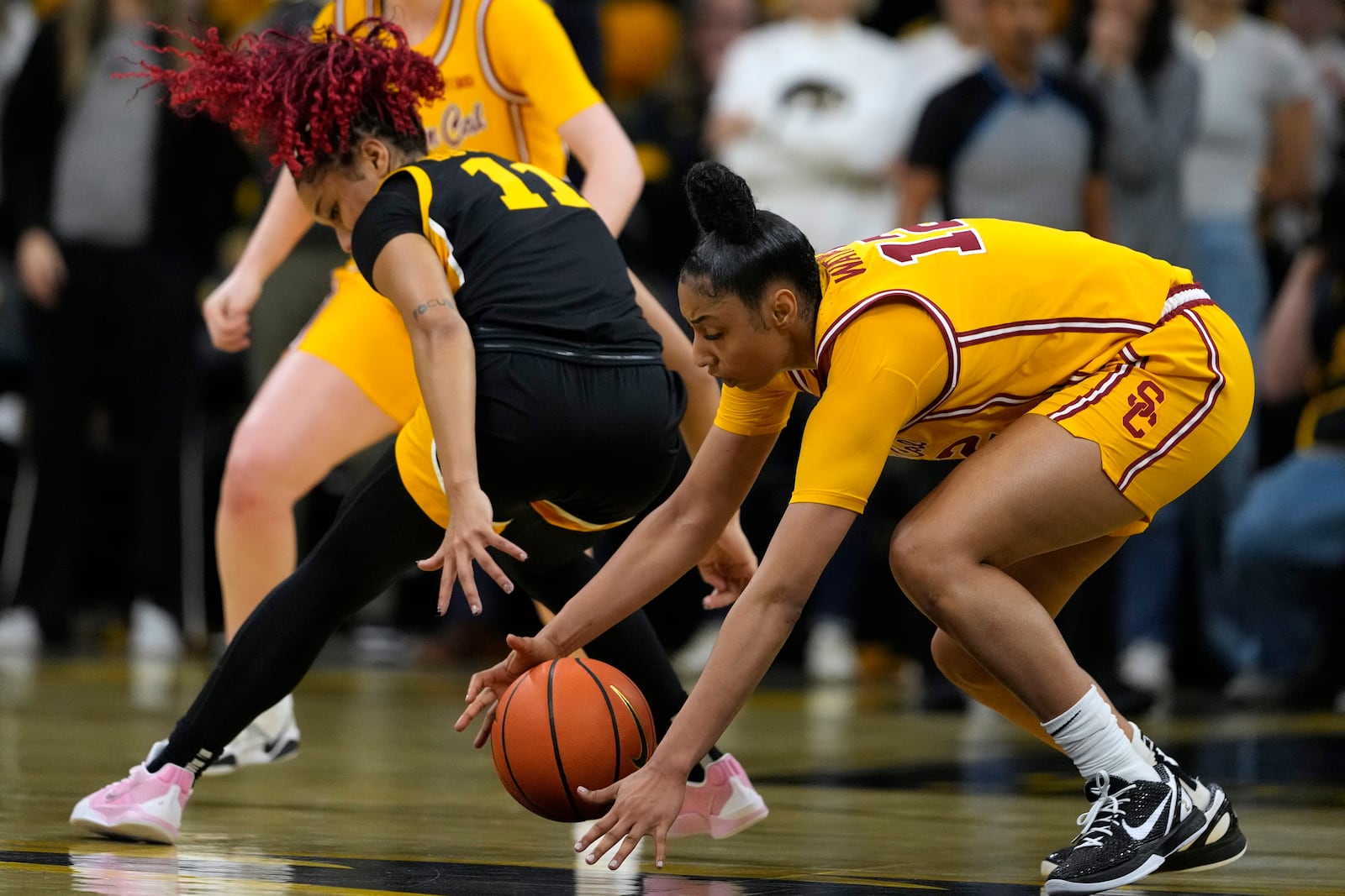 Southern California guard JuJu Watkins, right, steals the ball from Iowa guard Aaliyah Guyton (11) during the first half of an NCAA college basketball game, Sunday, Feb. 2, 2025, in Iowa City, Iowa. (AP Photo/Charlie Neibergall)