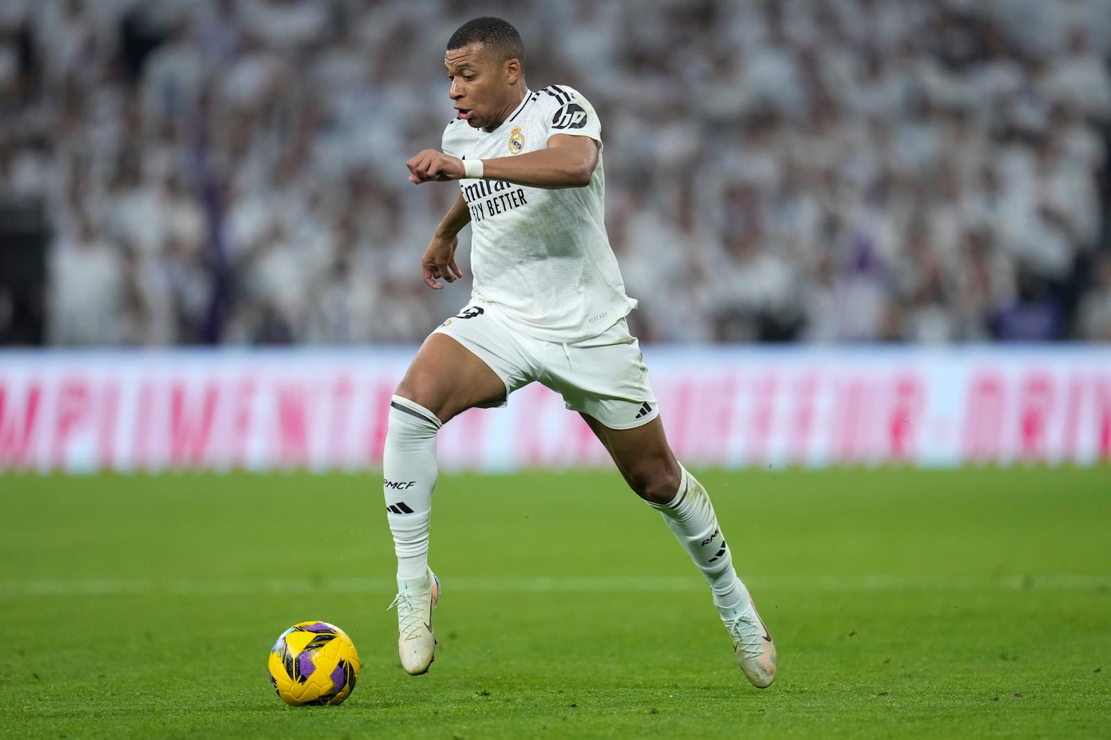 Real Madrid's Kylian Mbappe takes control of the ball during the Spanish La Liga soccer match between Real Madrid and Getafe at the Santiago Bernabeu Stadium in Madrid, Spain, Sunday, Dec. 1, 2024. (AP Photo/Bernat Armangue)