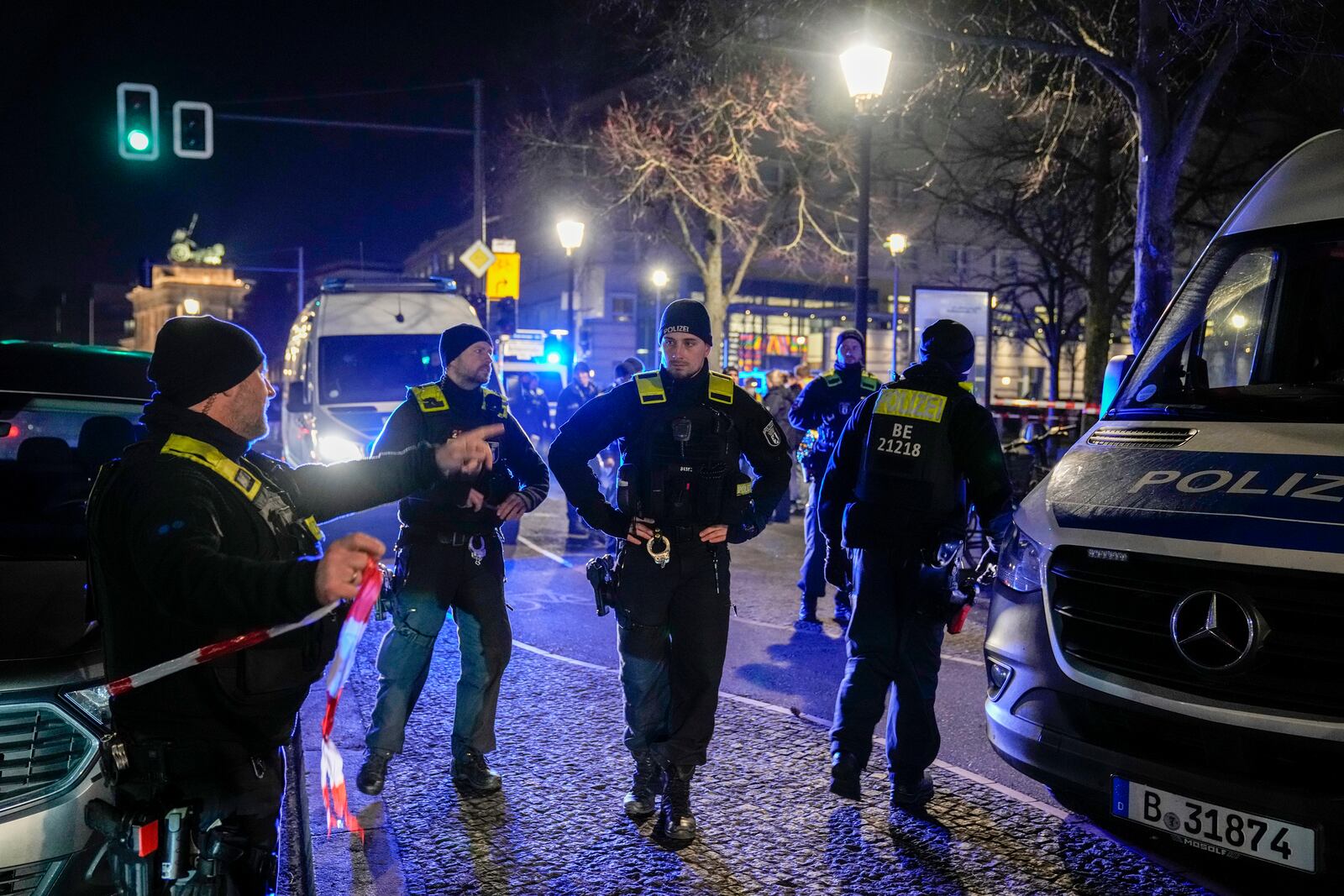 Police officers attend the scene at the Holocaust memorial after a man was attacked at the memorial site in Berlin, Germany, Friday, Feb. 21, 2025. (AP Photo/Ebrahim Noroozi)