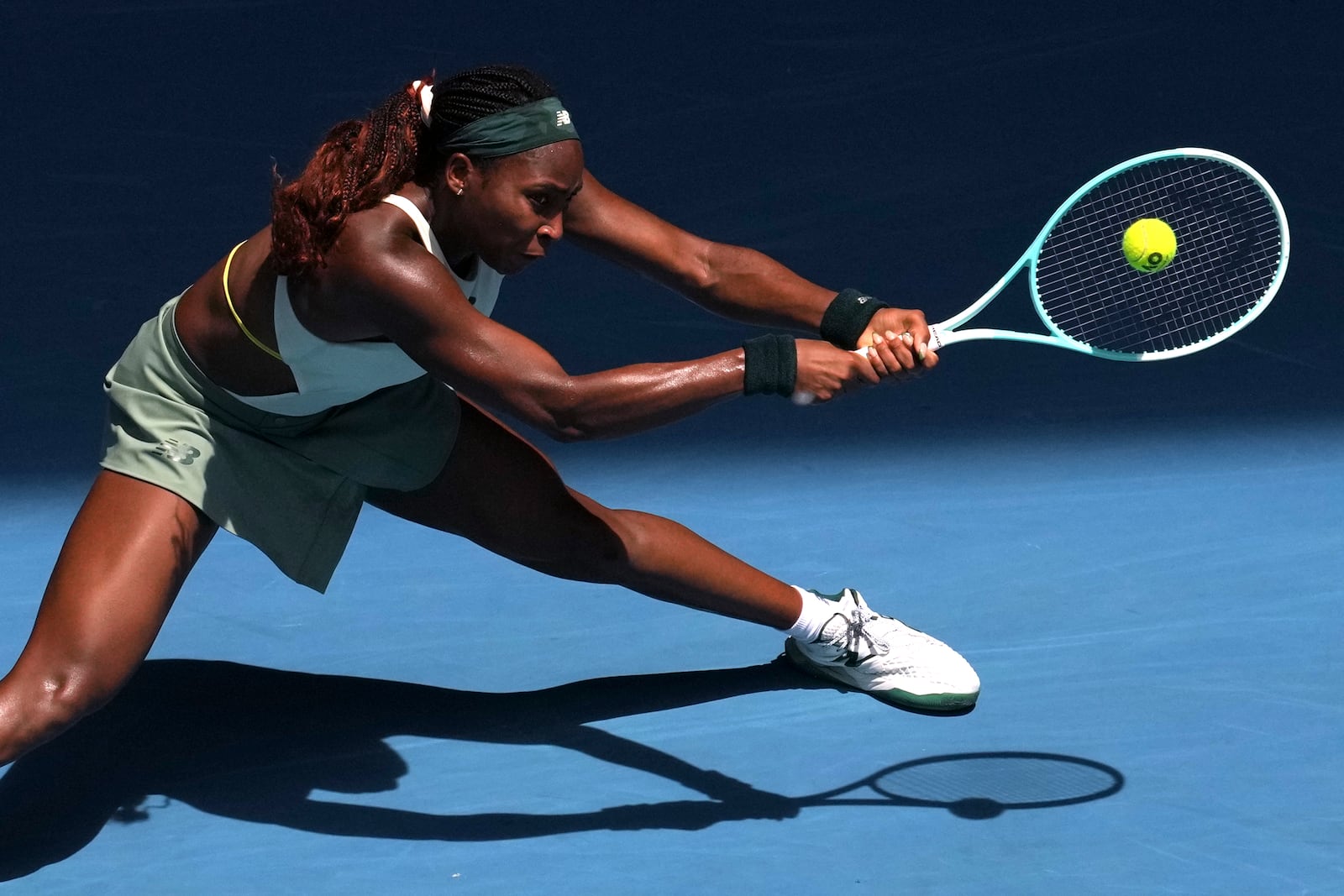 Coco Gauff of the U.S. returns a shot from Belinda Bencic of Switzerland during their fourth round match at the Australian Open tennis championship in Melbourne, Australia, Sunday, Jan. 19, 2025. (AP Photo/Mark Baker)