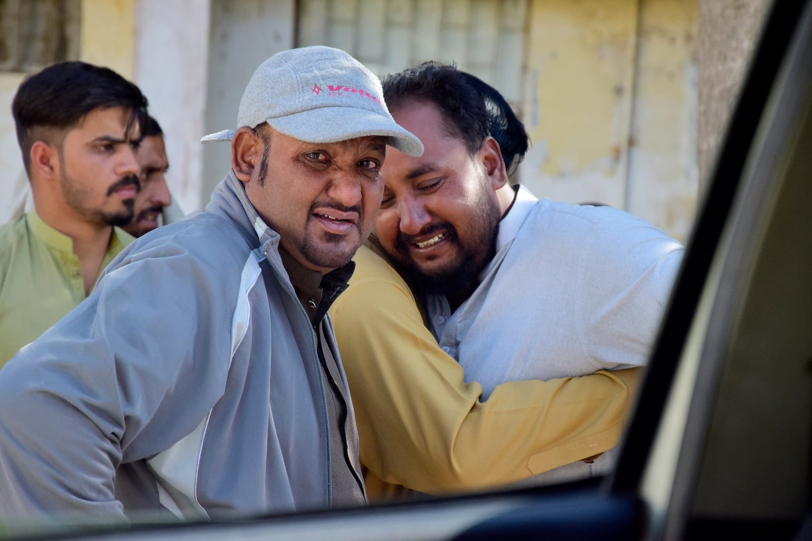 People mourn next to an ambulance after receiving body of a victim of a bomb explosion at railway station, outside a hospital, in Quetta, southwestern Pakistan, Saturday, Nov. 9, 2024. (AP Photo/Arshad Butt)