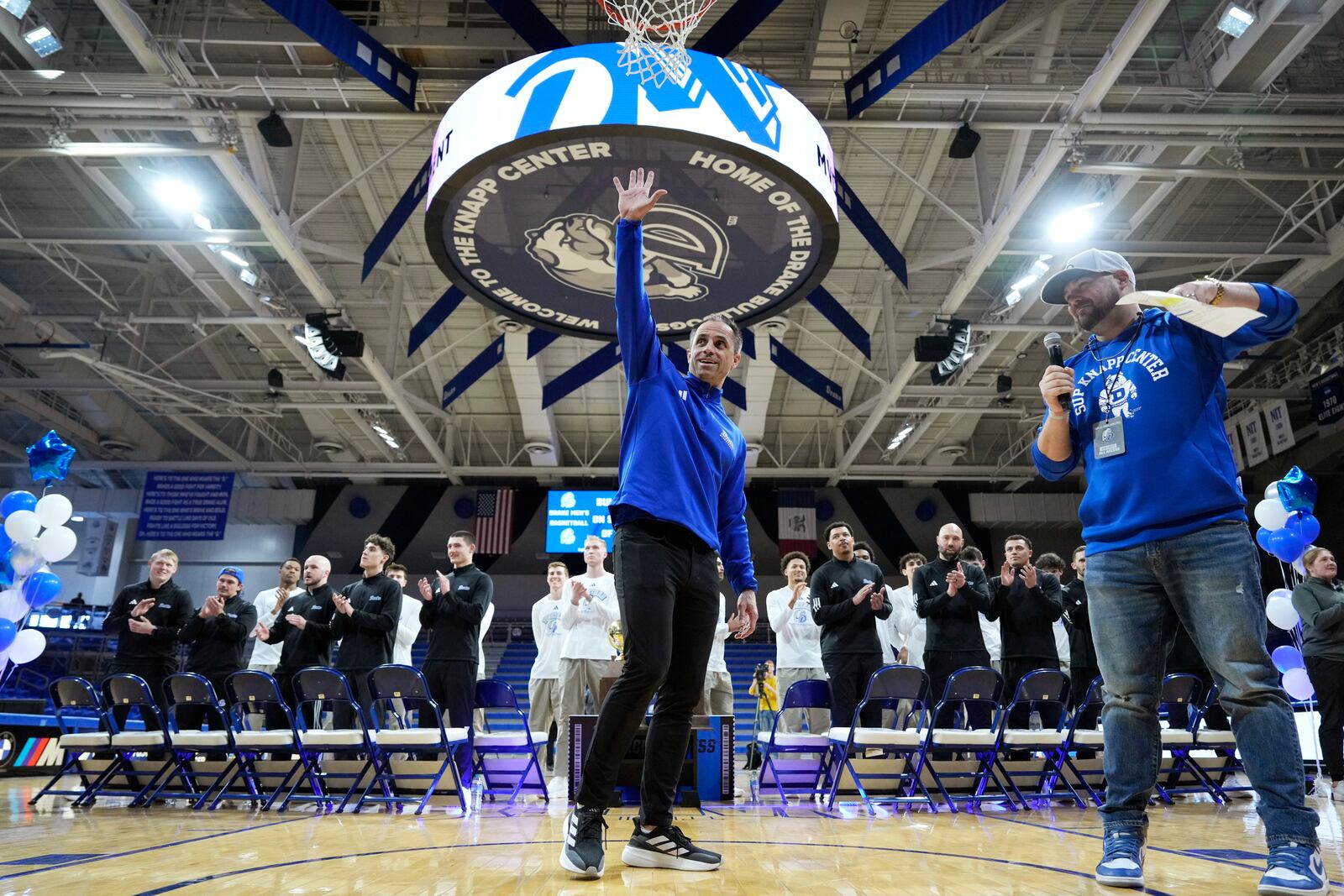 Drake head coach Ben McCollum waves to fans before watching the broadcast of the NCAA men's basketball tournament selection show with his team, Sunday, March 16, 2025, in Des Moines, Iowa. (AP Photo/Charlie Neibergall)