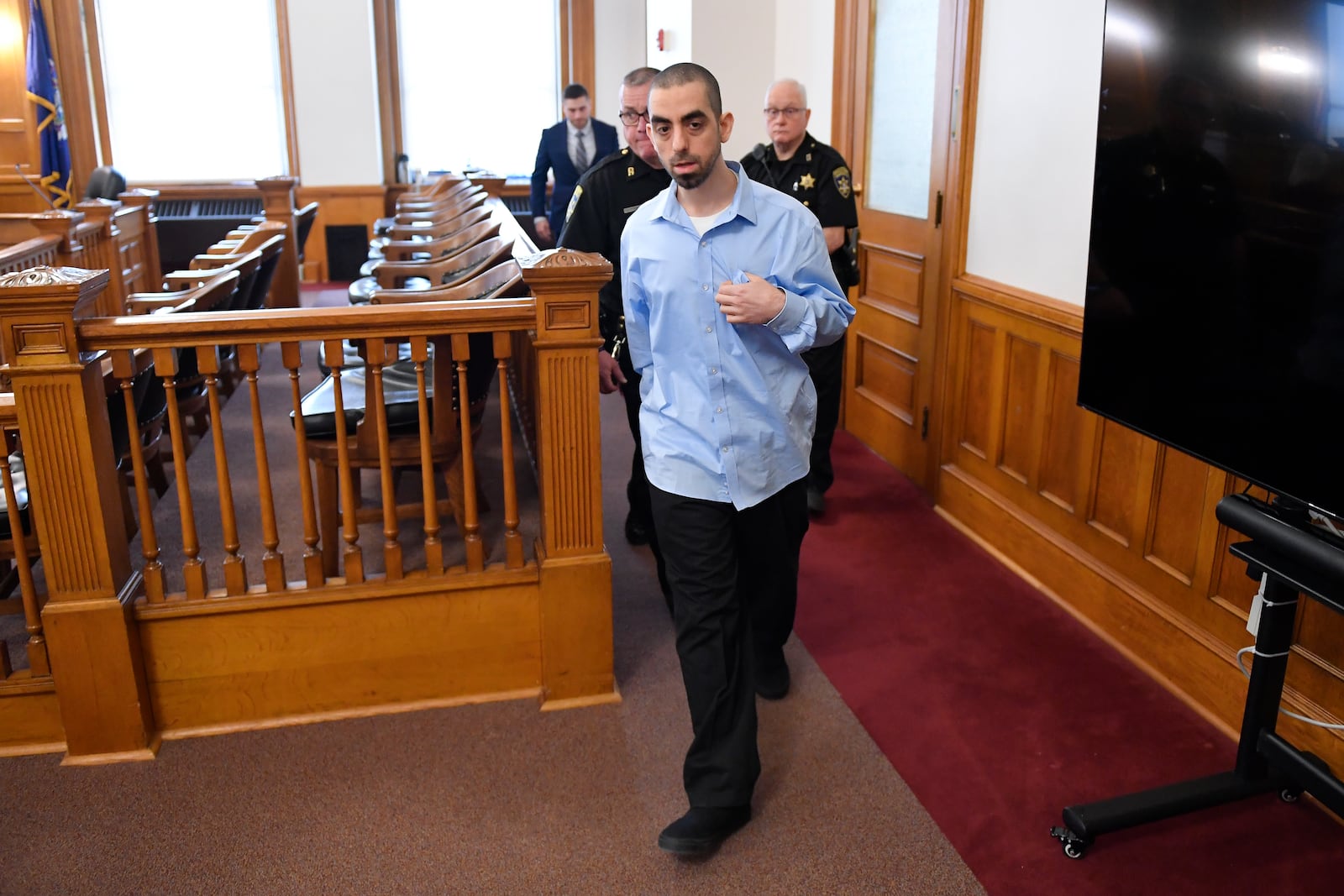 Hadi Matar, charged with severely injuring author Salman Rushdie in a 2022 knife attack, is led in to Chautauqua County court in Mayville, N.Y., Monday, Feb. 10, 2025. (AP Photo/Adrian Kraus)