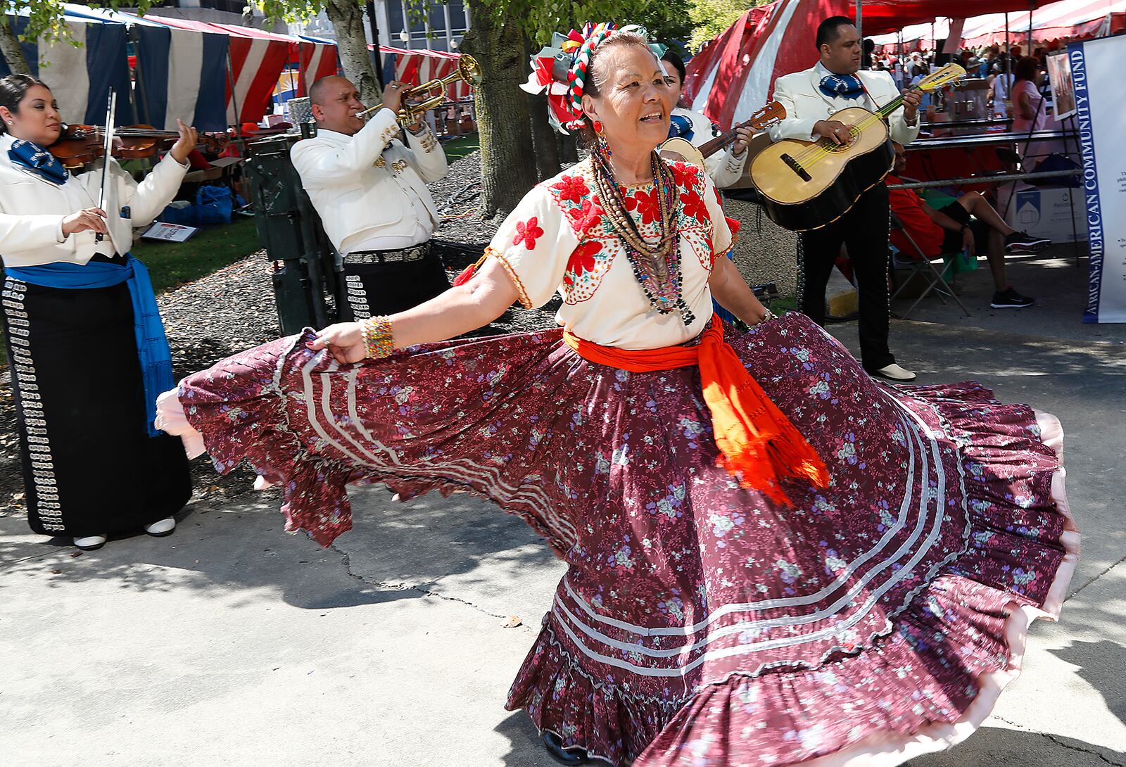 Beatriz Koehler dances to the music of the mariachi band Zelaya at CultureFest in downtown Springfield. Bill Lackey/Staff