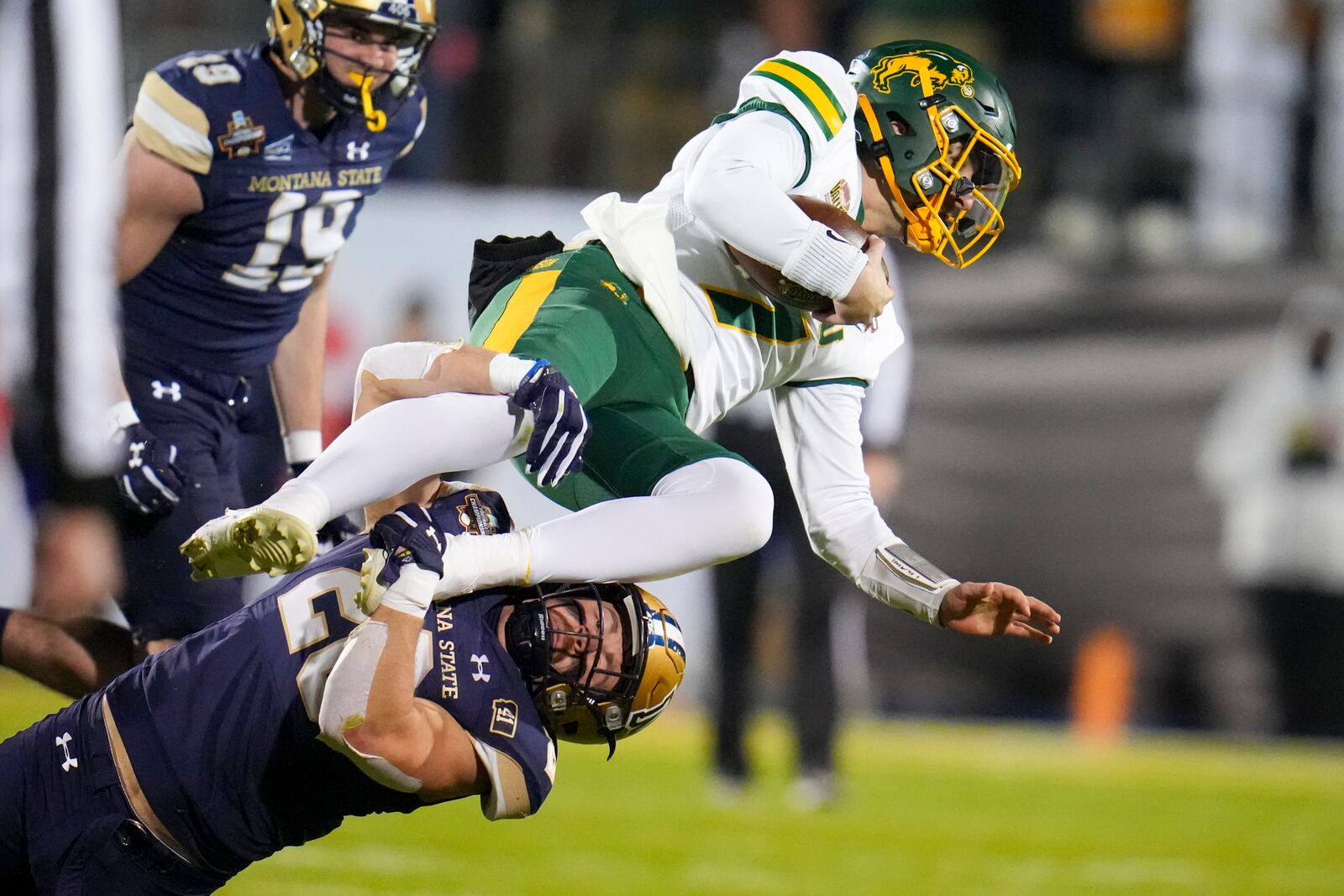 North Dakota State quarterback Cam Miller, top, is tackled by Montana State defensive back Rylan Ortt during the first half of the FCS Championship NCAA college football game, Monday, Jan. 6, 2025, in Frisco, Texas. (AP Photo/Julio Cortez)