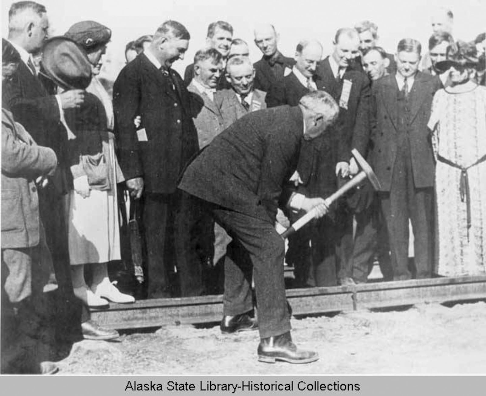 In this image, July 15, 1923, provided by the Alaska State Library Historical Collections, President Warren G. Harding drives the final golden spike at the new Alaska Railroad bridge in Nenana, Alaska. (Alaska State Library via AP)