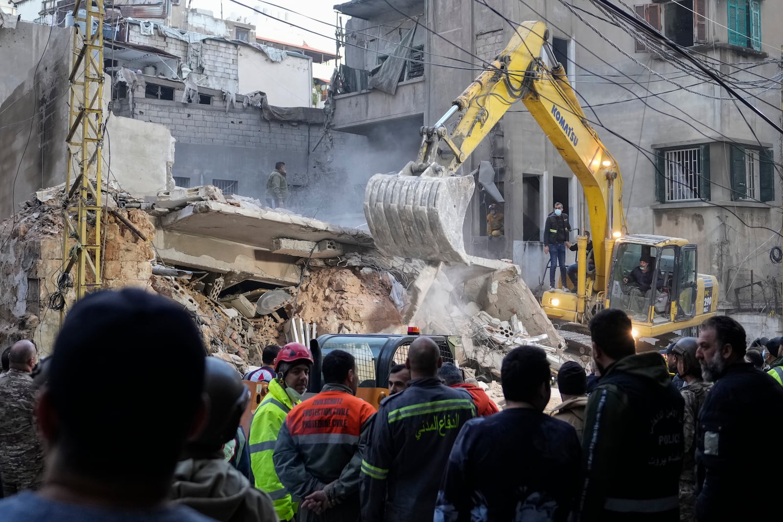 Rescuers use an excavator as they search for victims at the site of an Israeli airstrike that hit a building in Beirut, Tuesday, Nov. 26, 2024. (AP Photo/Hassan Ammar)