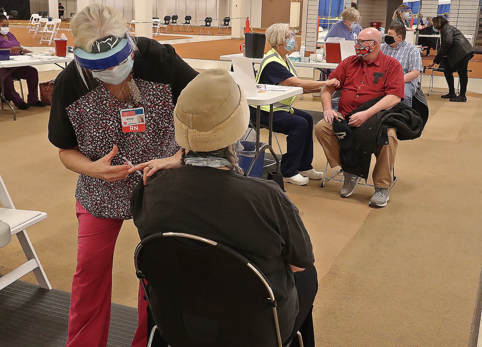 Clark County residents get their COVID vaccine shots at the Clark County Combined Health District's vaccine distribution center at the Upper Valley Mall Tuesday, Feb. 23, 2021. BILL LACKEY/STAFF