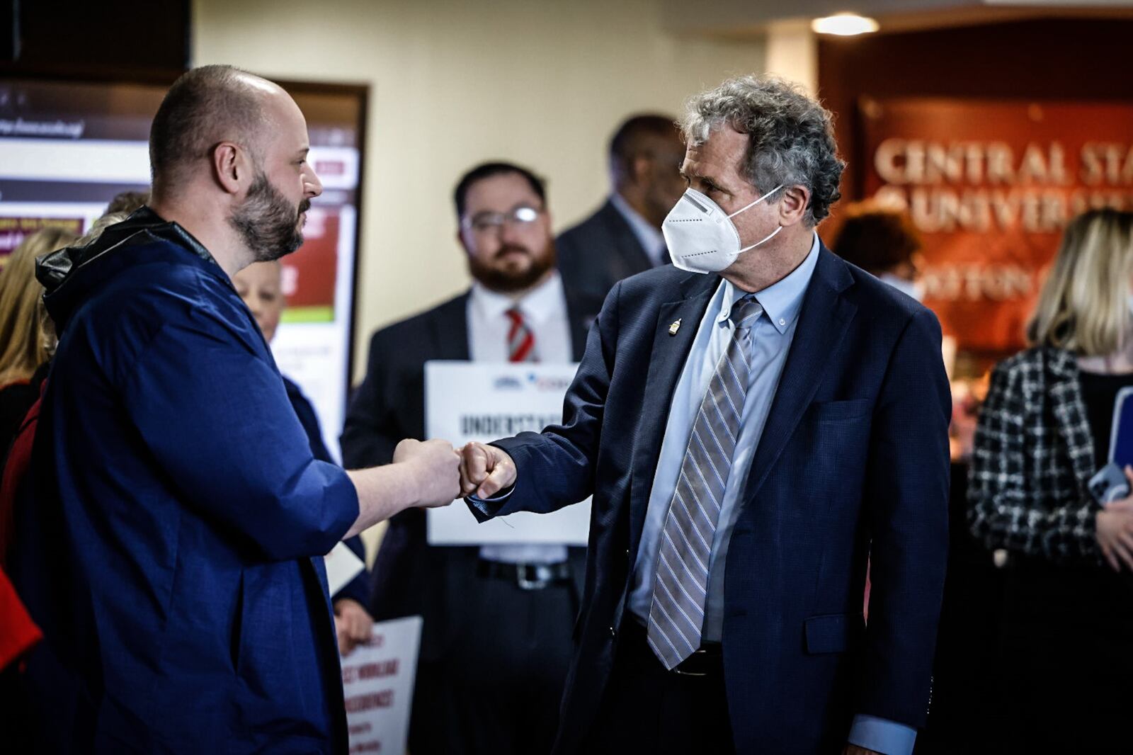 Ohio Sen. Sherrod Brown fist pumps Rick Lucas, president and executive director of the Ohio Nurses Association, during a a press conference Tuesday April 11, 2023 at Central State West Campus. Senator Brown is co-sponsoring a bill in congress called the nurse staffing standards for hospital patient safety and quality act. JIM NOELKER/STAFF