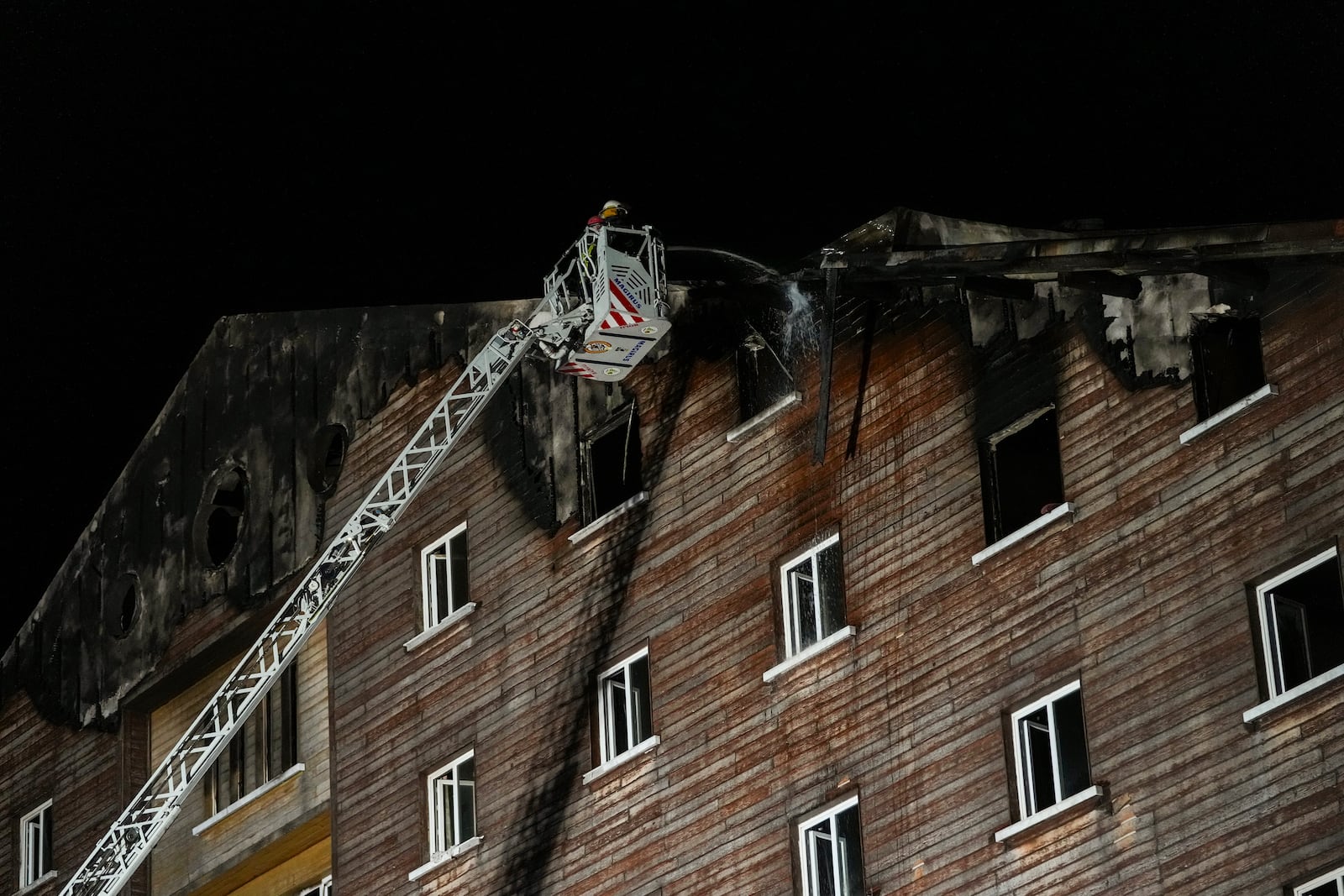 Firefighters work on the aftermath of a fire that broke out at a hotel in the ski resort of Kartalkaya, located in Bolu province, northwest Turkey, on Tuesday, Jan. 21, 2025. (AP Photo/Francisco Seco)