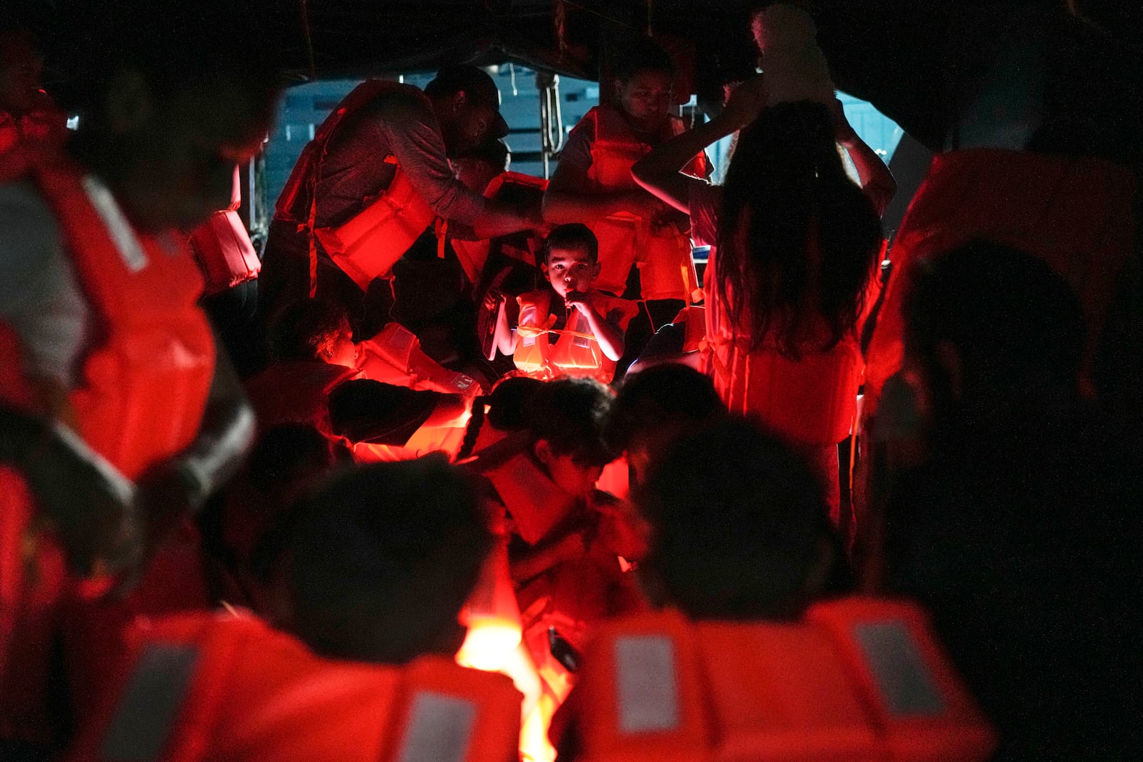 Migrants board a boat at the Caribbean coastal village of Miramar, Panama, bound for the Colombian border, Thursday, Feb. 27, 2025, as migrants return from southern Mexico after abandoning hopes of reaching the U.S. in a reverse flow triggered by the Trump administration's immigration crackdown. (AP Photo/Matias Delacroix)