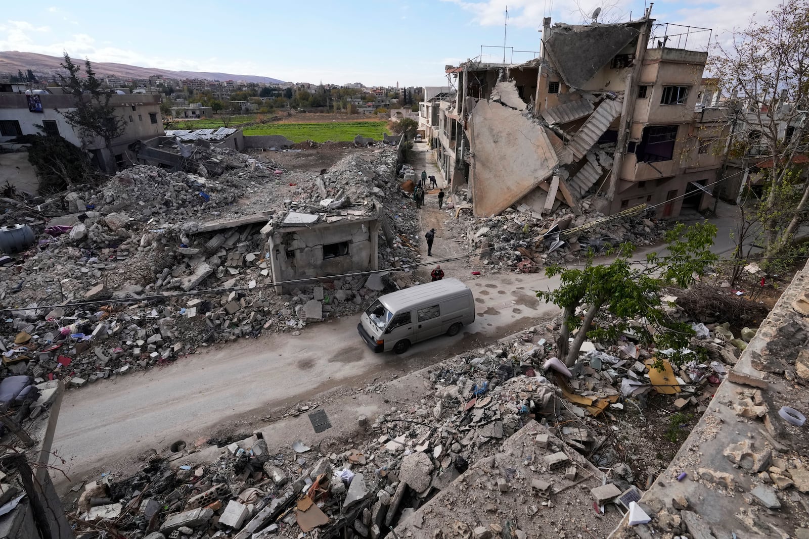 Residents inspect a destroyed neighbourhood in Baalbek, eastern Lebanon, Thursday, Nov. 28, 2024. (AP Photo/Hassan Ammar)