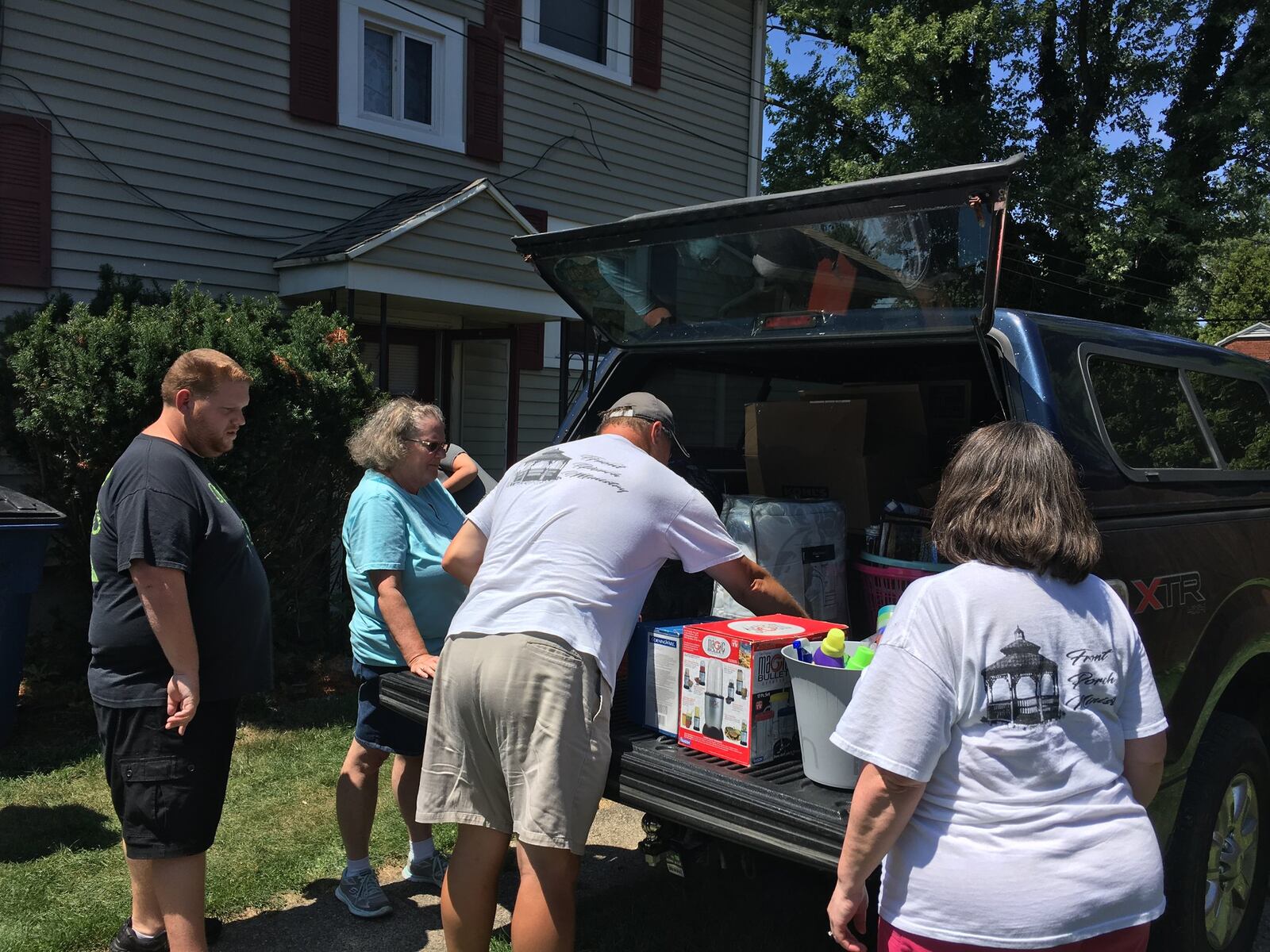 Volunteers for the Shiloh Tornado Assistance for Families program help move donated items into the home. BONNIE MEIBERS/STAFF