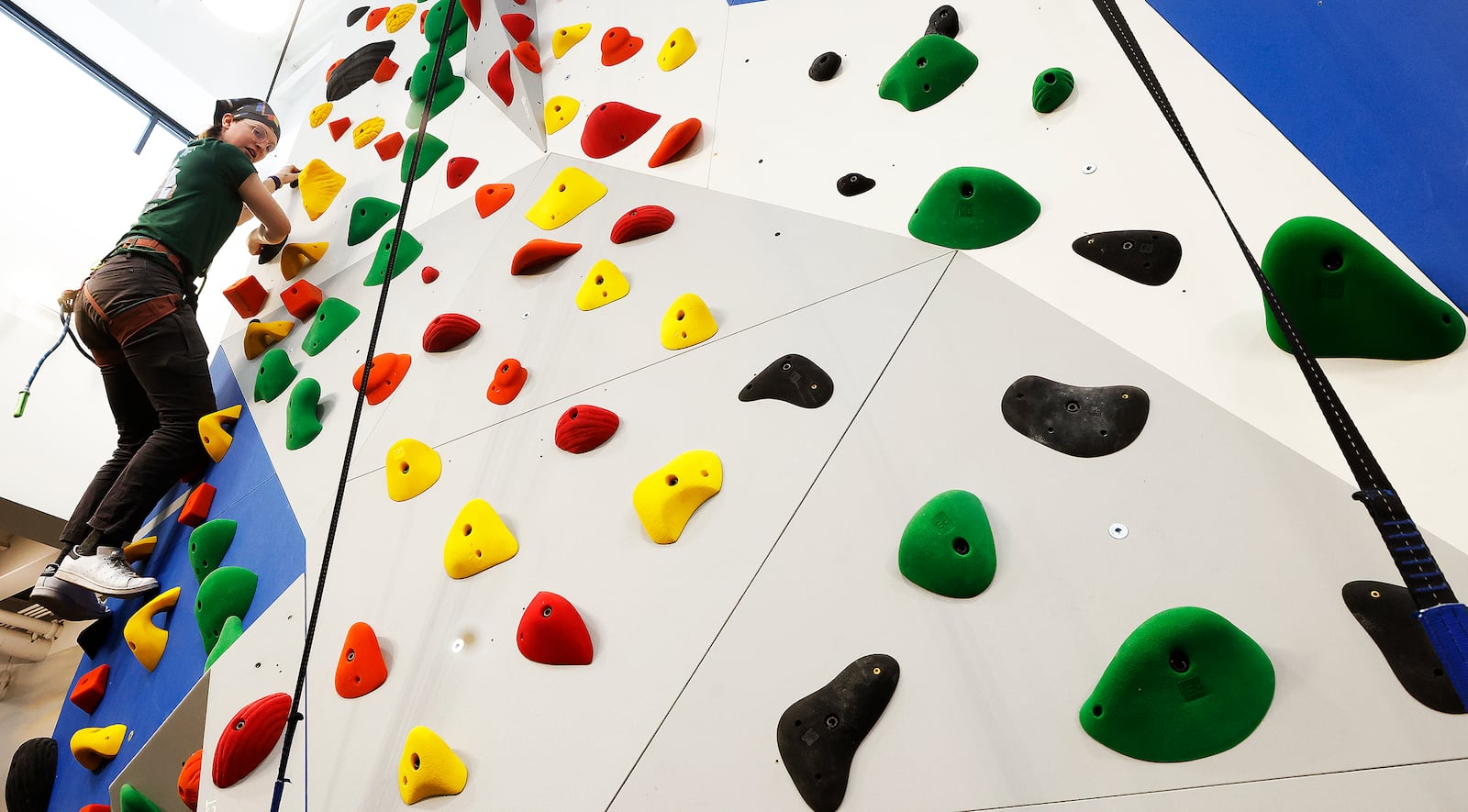 Staff member Aspen Goodwin safety-checks the rock climbing routes inside the new Dick's House of Sports at the Mall at Fairfield Commons. The grand opening was Friday, March 7, 2025. MARSHALL GORBY\STAFF