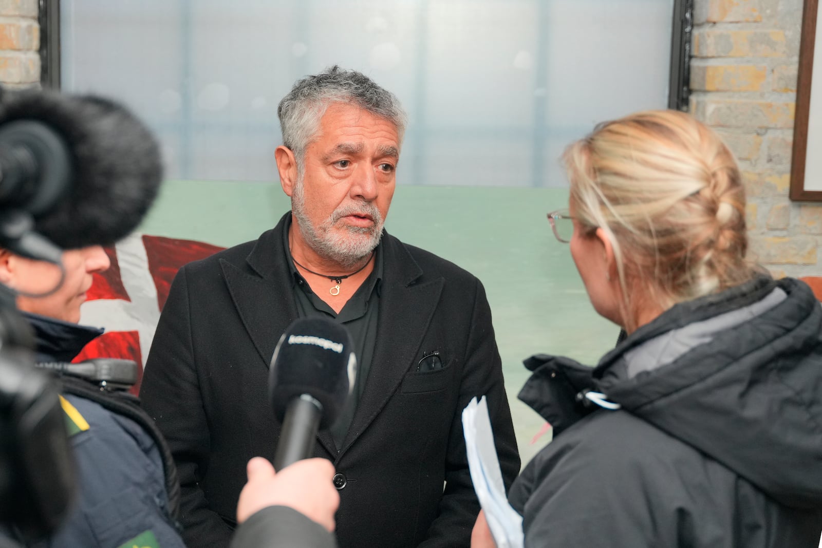 Police speak to Marco Evaristti at his exhibition "And Now You Care", in the Grey Meatpacking District in Copenhagen, Friday Feb. 28, 2025. (Emil Helms/Ritzau Scanpix via AP)