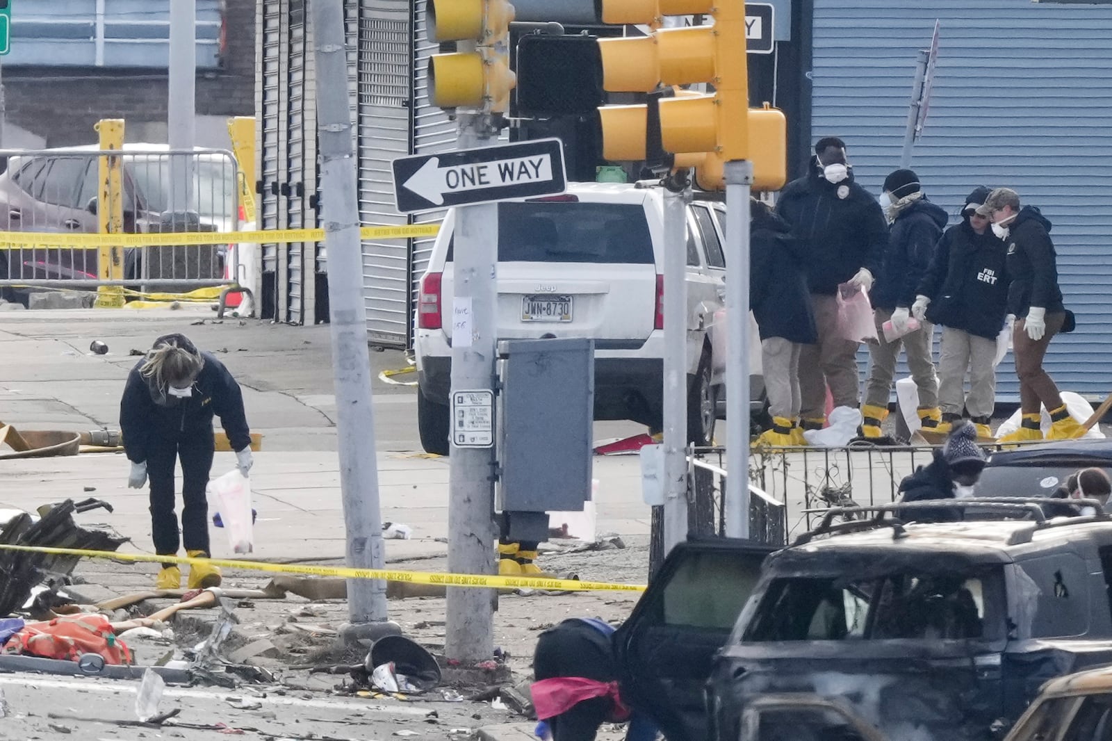 Investigators work the scene after a small plane crashed in Philadelphia, Saturday, Feb. 1, 2025. (AP Photo/Matt Rourke)