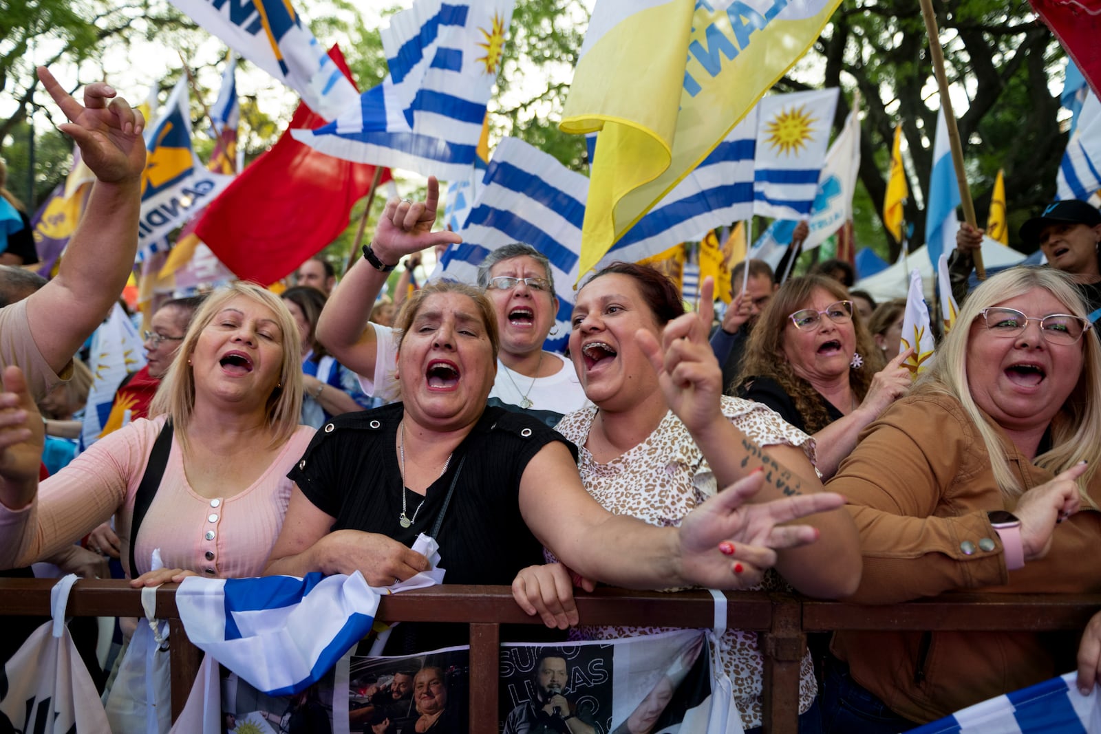 Supporters of Alvaro Delgado, presidential candidate for the ruling National Party, attend his closing rally ahead of the presidential run-off election in Montevideo, Uruguay, Wednesday, Nov. 20, 2024. (AP Photo/Santiago Mazzarovich)