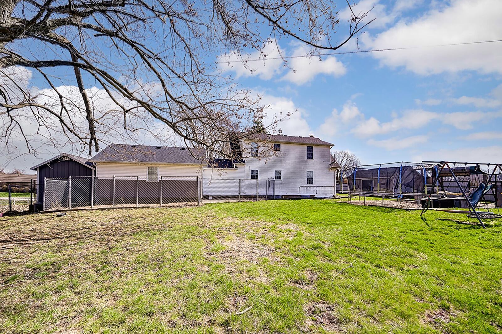 the rear of the home is fenced with chain link and wood privacy. There is also a separate fenced dog run, a mulched play area with elevated play house and a chicken coop.