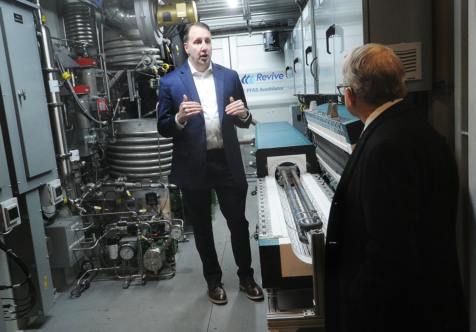 David Trueba, president and CEO of Revive Environmental Technology, walks Ohio Gov. Mike DeWine through the new technology at Wright State University's Calamityville campus Monday, March 18, 2024. The event officially launch's Ohio's new statewide program to annihilate hazardous per- and polyfluoroalkyl substances (PFAS) in firefighting foam. MARSHALL GORBY\STAFF