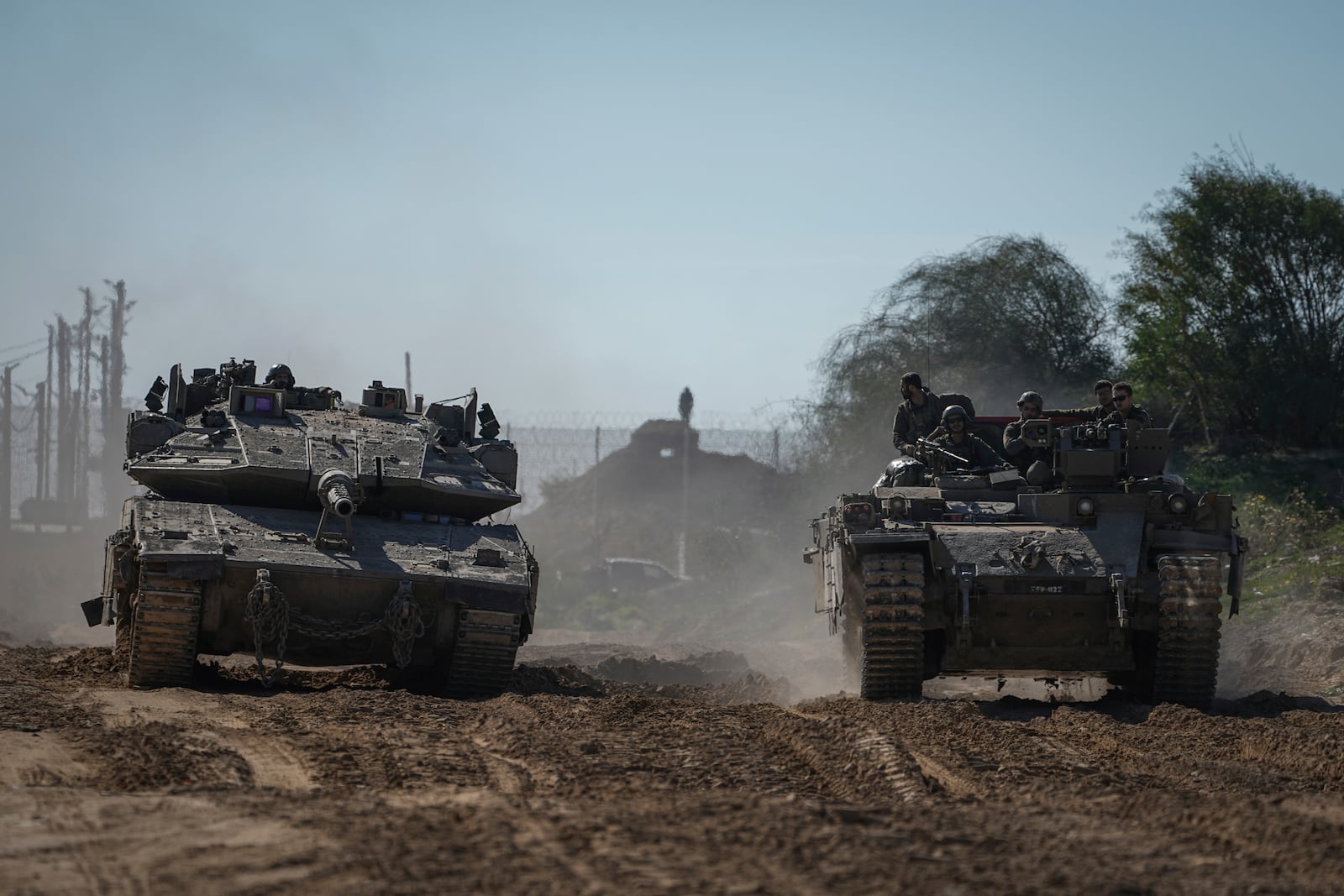 Israeli troops are crossing into Israel from the Gaza Strip, Saturday, Jan. 18, 2025. (AP Photo/Tsafrir Abayov)