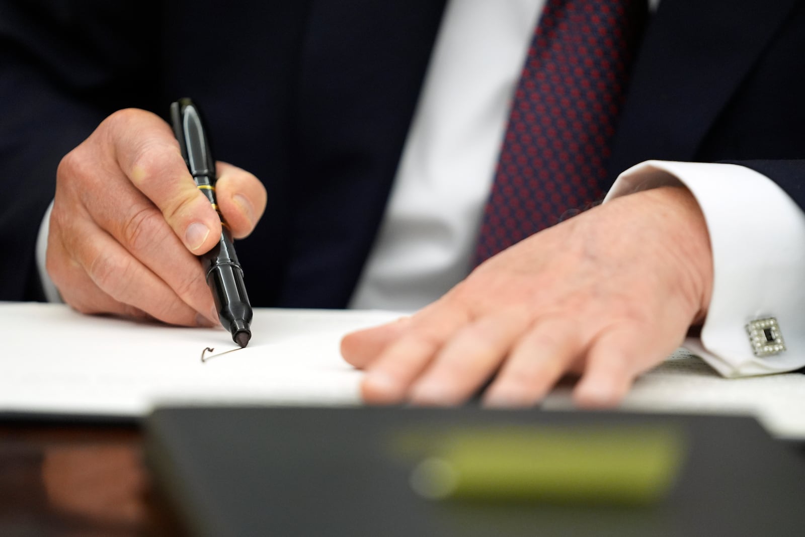 President Donald Trump signs executive orders in the Oval Office of the White House, Monday, Jan. 20, 2025, in Washington. (AP Photo/Evan Vucci)