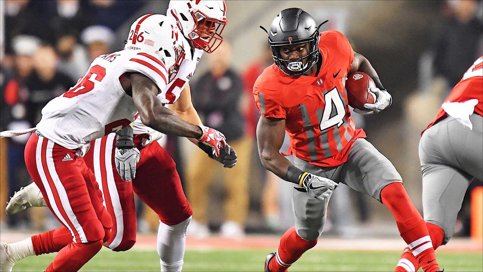 COLUMBUS, OH - NOVEMBER 5:  Curtis Samuel #4 of the Ohio State Buckeyes looks for running room around Thomas Connely #26 of the Nebraska Cornhuskers and Josh Banderas #52 of the Nebraska Cornhuskers in the second quarter at Ohio Stadium on November 5, 2016 in Columbus, Ohio.  (Photo by Jamie Sabau/Getty Images)